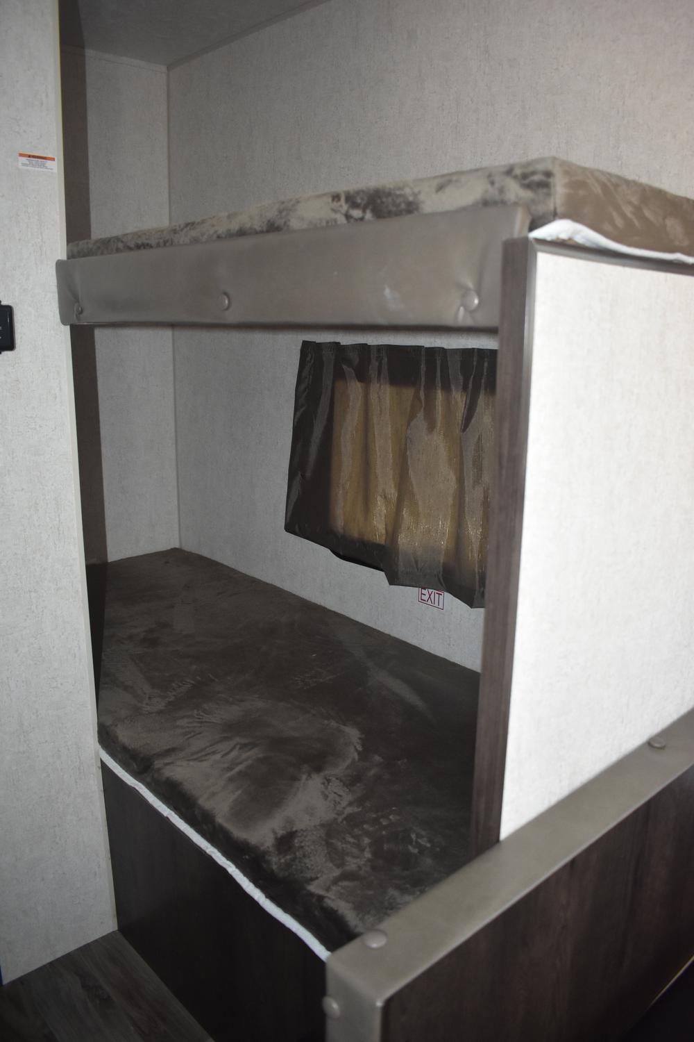RV rental bunk beds: A view of the cozy sleeping area with a small window and emergency exit sign for safety.. Starcraft AR-One Maxx 2016