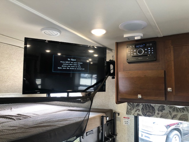 RV rental entertainment setup: TV displaying 'No Signal,' integrated stereo, and a bunk bed with netting.. Forest River Forester 2017