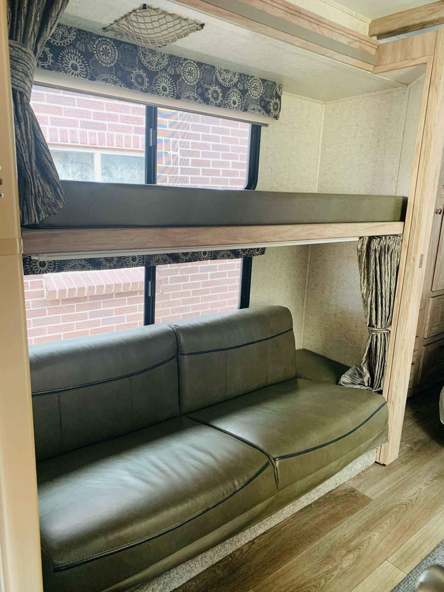 Cozy RV rental interior features bunk beds and a comfortable couch, ideal for family travel.. Forest River Sunseeker 2017