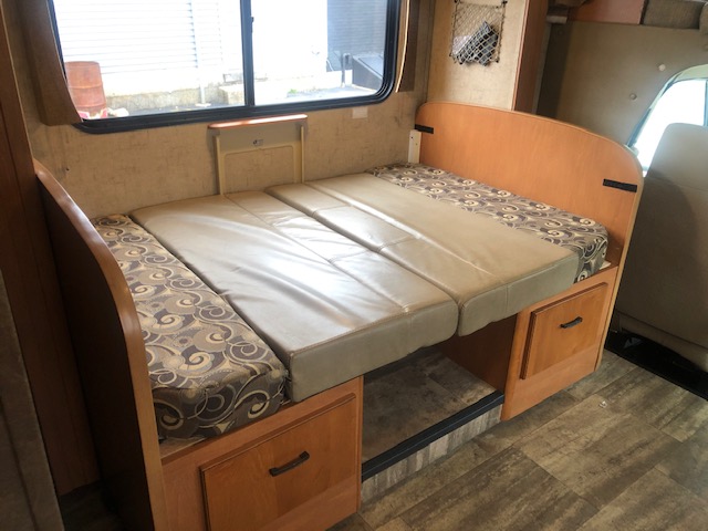 This RV rental features a versatile dinette area, easily converting into a comfortable bed for guests.. Forest River Sunseeker 2016