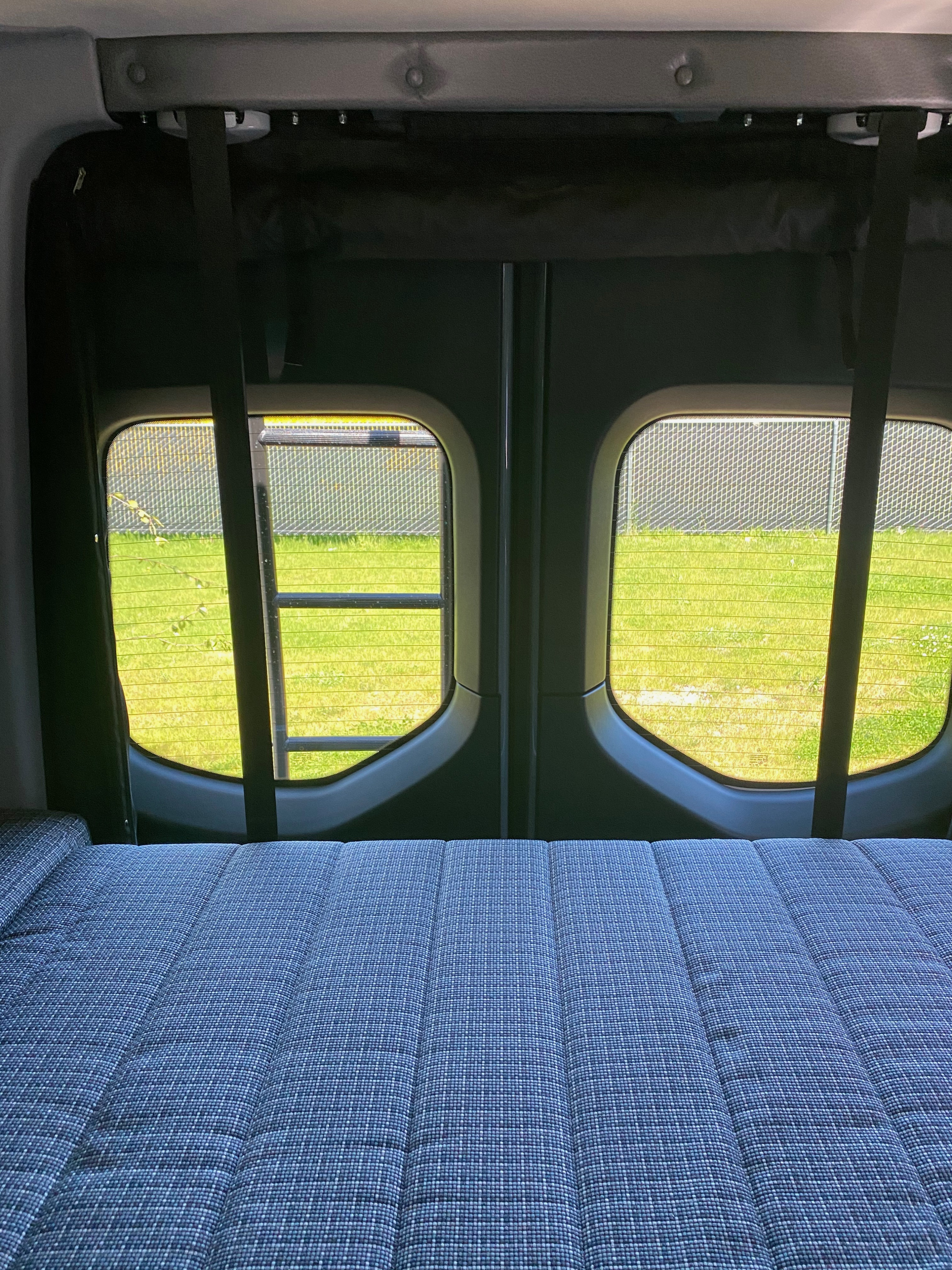 Queen bed located in the rear of the vehicle.. Winnebago Revel 2022