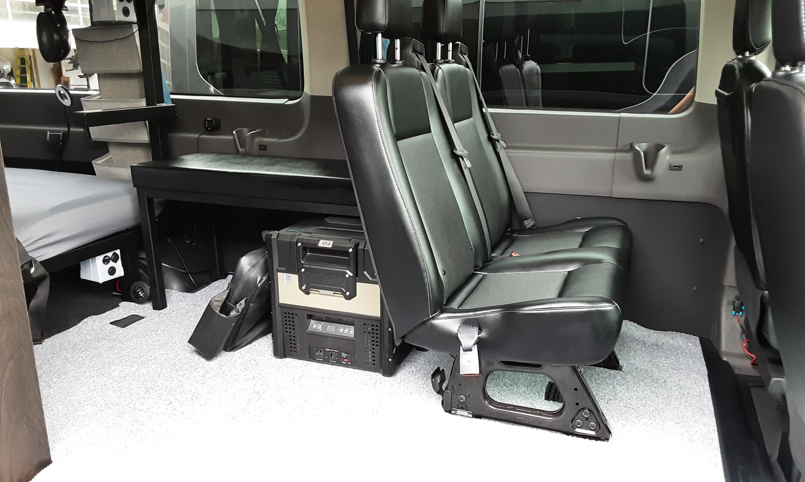 RV rental: Campervan interior with bed, 2nd-row seats, portable fridge, and convenient power outlets.. Ford transit 2017