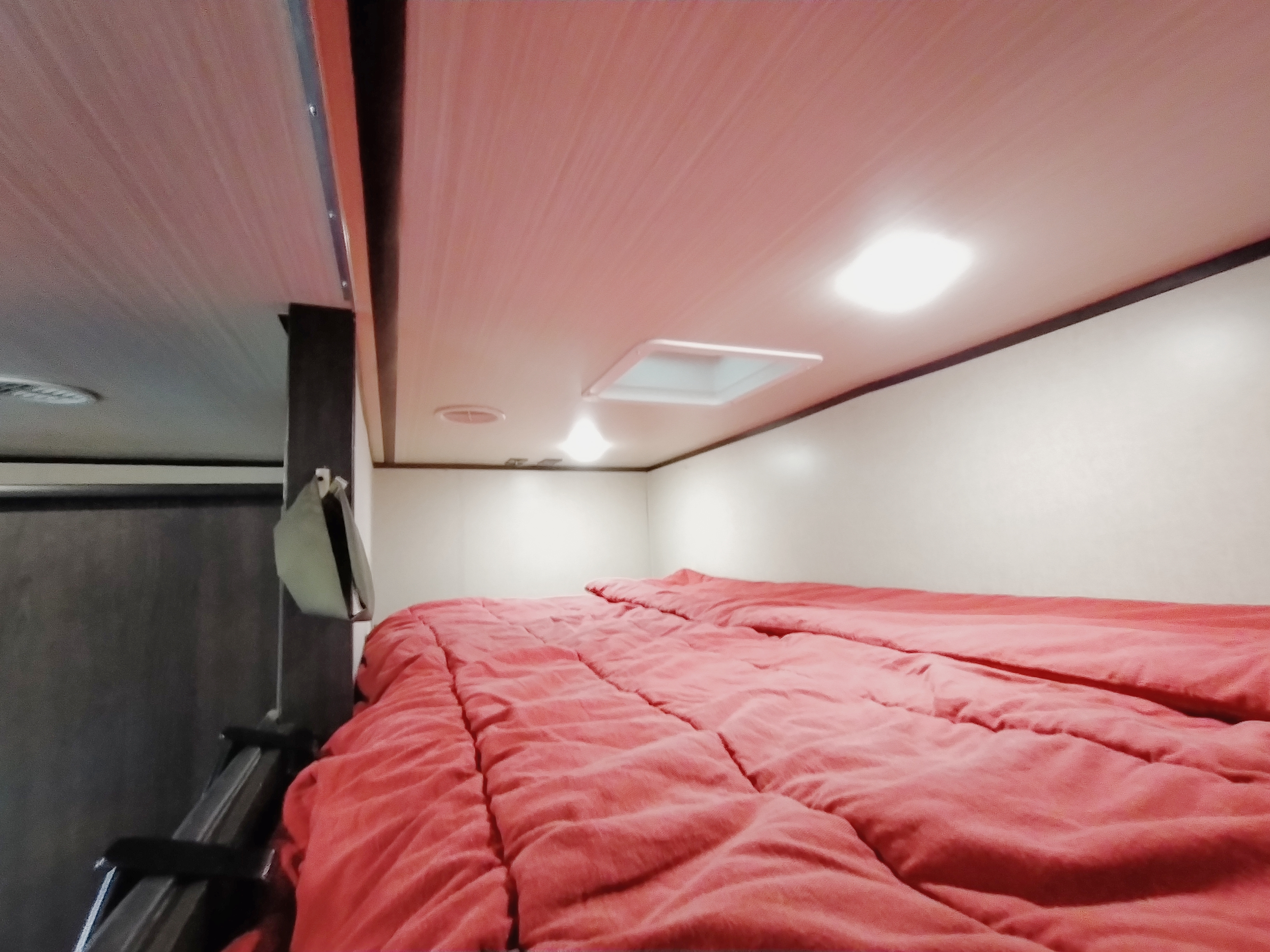 Loft space has twin mattress and linens. Forest River XLR Nitro Toy Hauler 2020