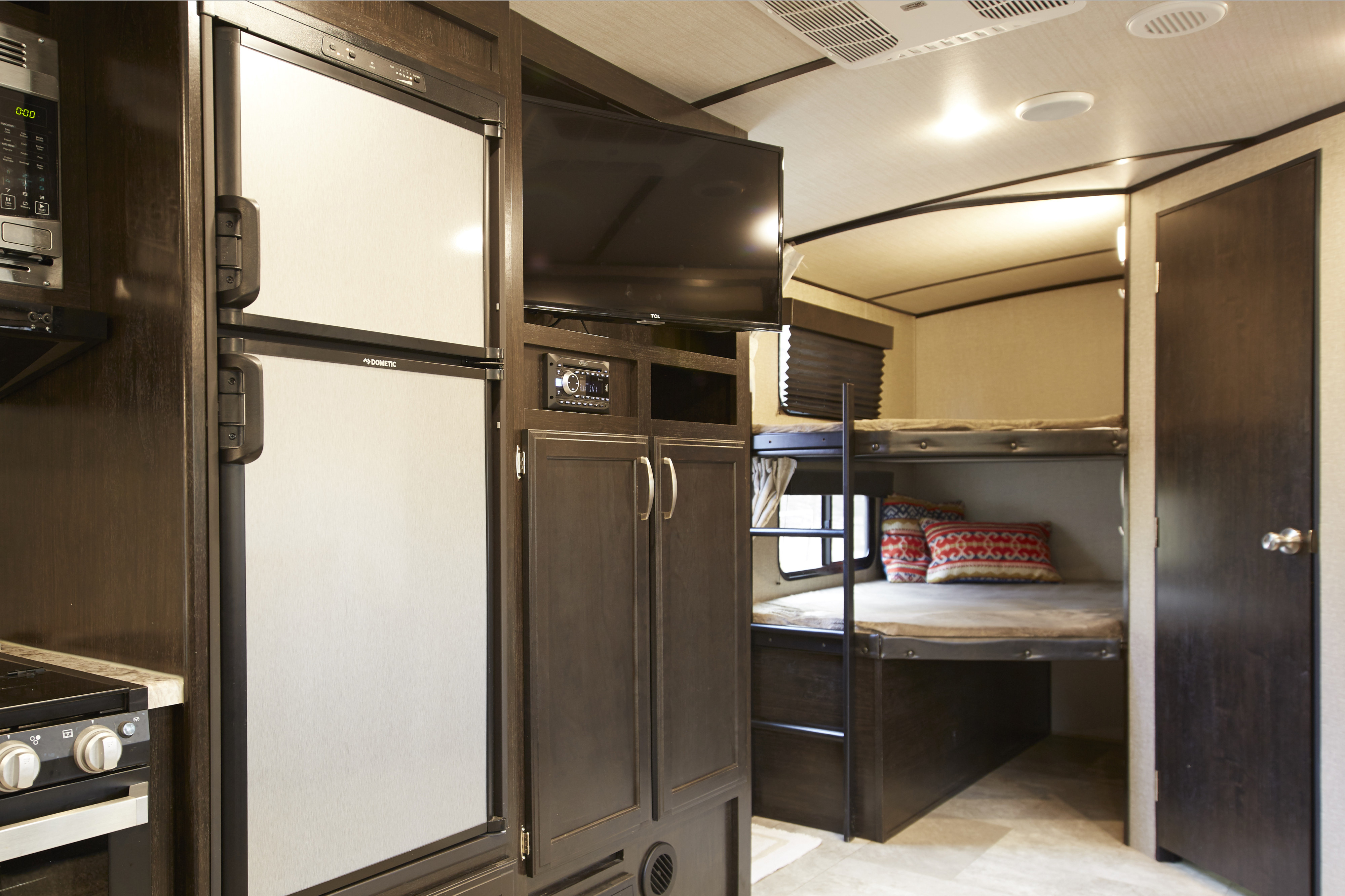 This RV rental features a modern kitchen with Dometic fridge, entertainment unit, & spacious bunk beds. Great for travel.. Grand Design Imagine 2019