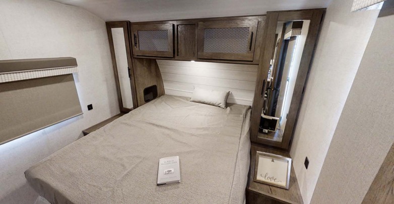 Modern RV rental bedroom: full bed, shiplap headboard, mesh cabinets, and window. Relaxing travel accommodations.. Forest River Salem 2021