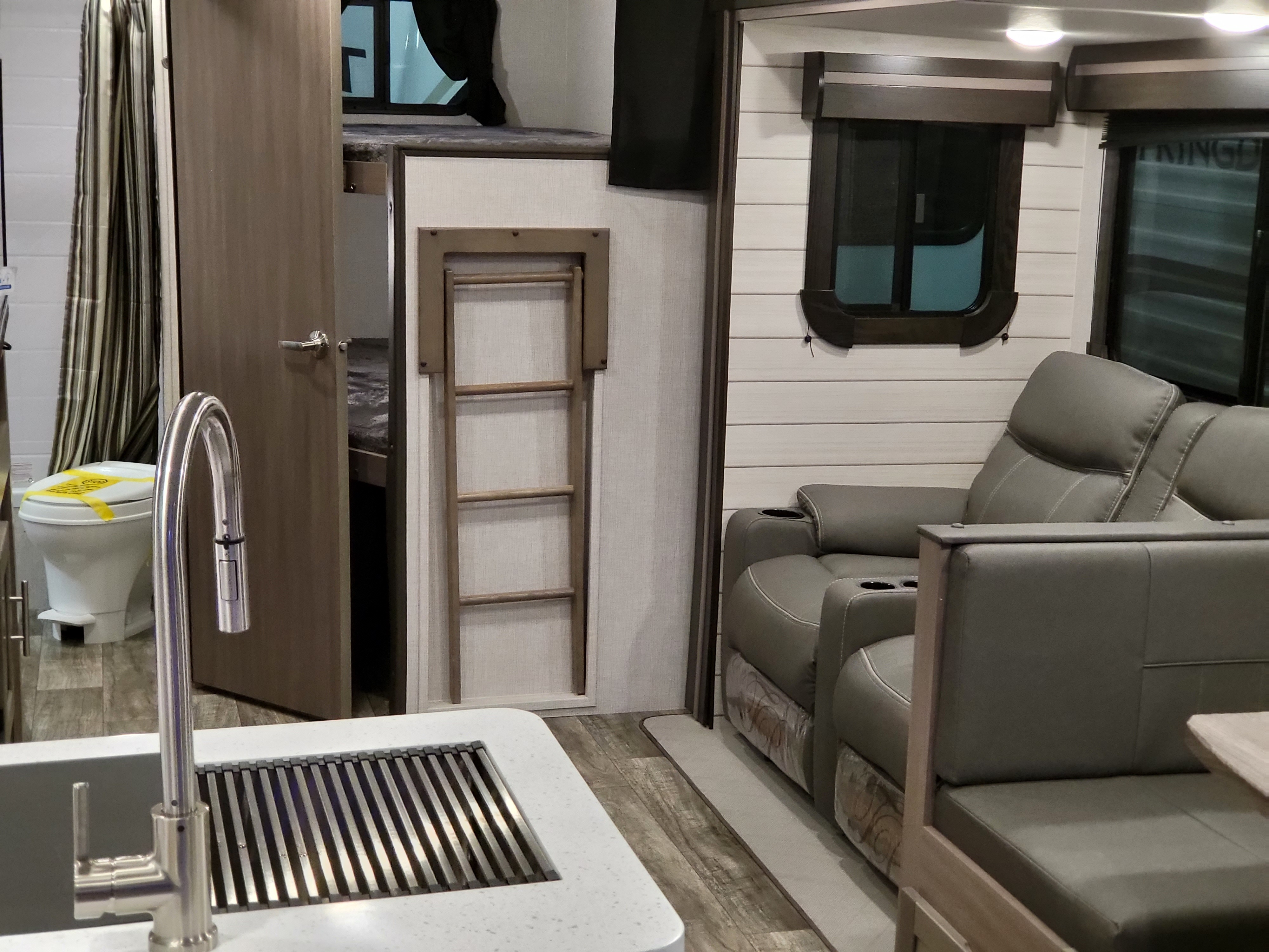 Spacious RV rental interior featuring a kitchen, bathroom, bunk beds, and comfortable recliner seating.. Crossroads RV Sunset Trail Super Lite 2022
