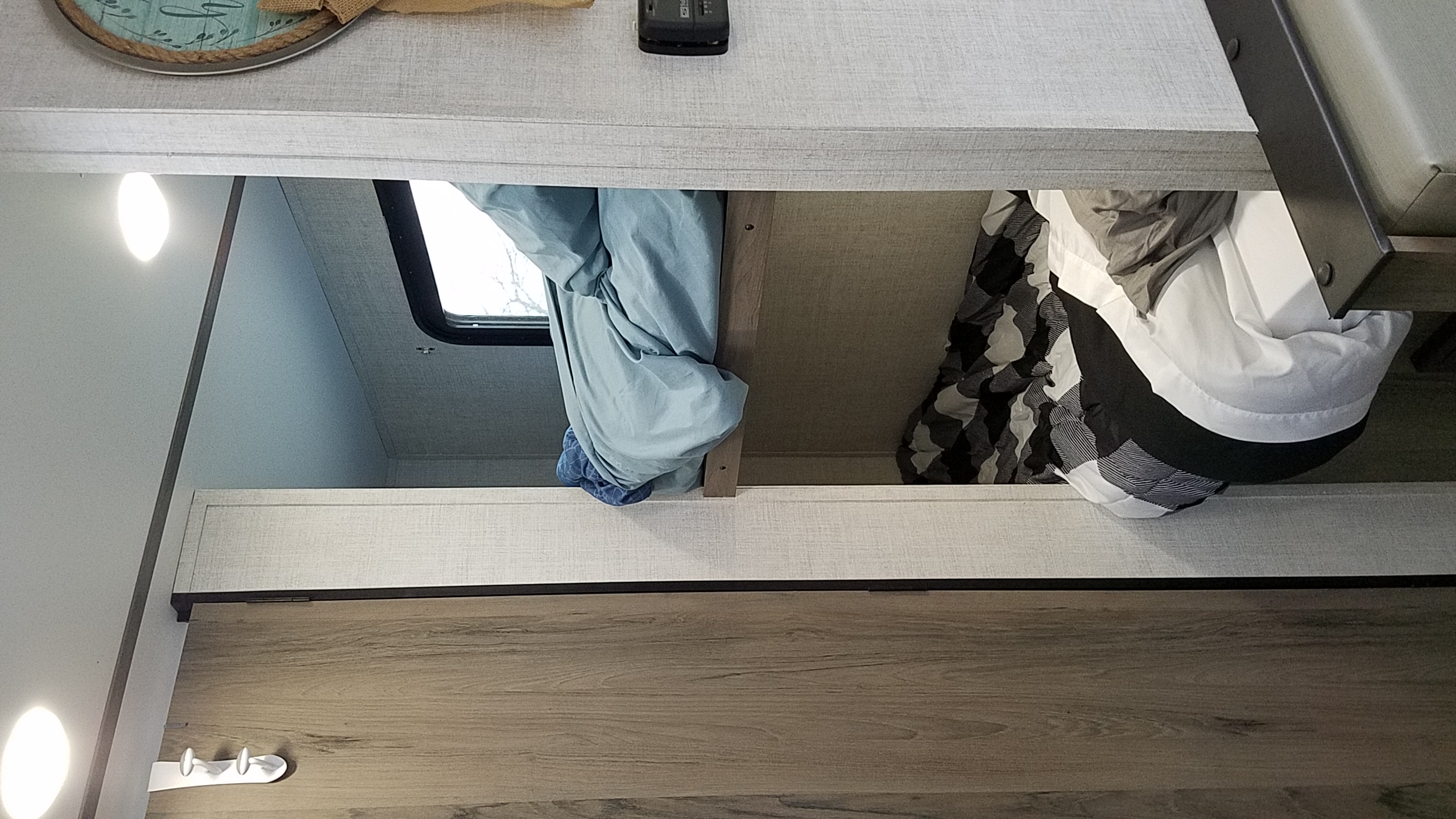 RV rental's bunk beds offer practical, compact sleeping. This modern interior features a two-tier setup with light wood and gray surfaces.. Gulf Stream Ameri-Lite Super Lite 2021