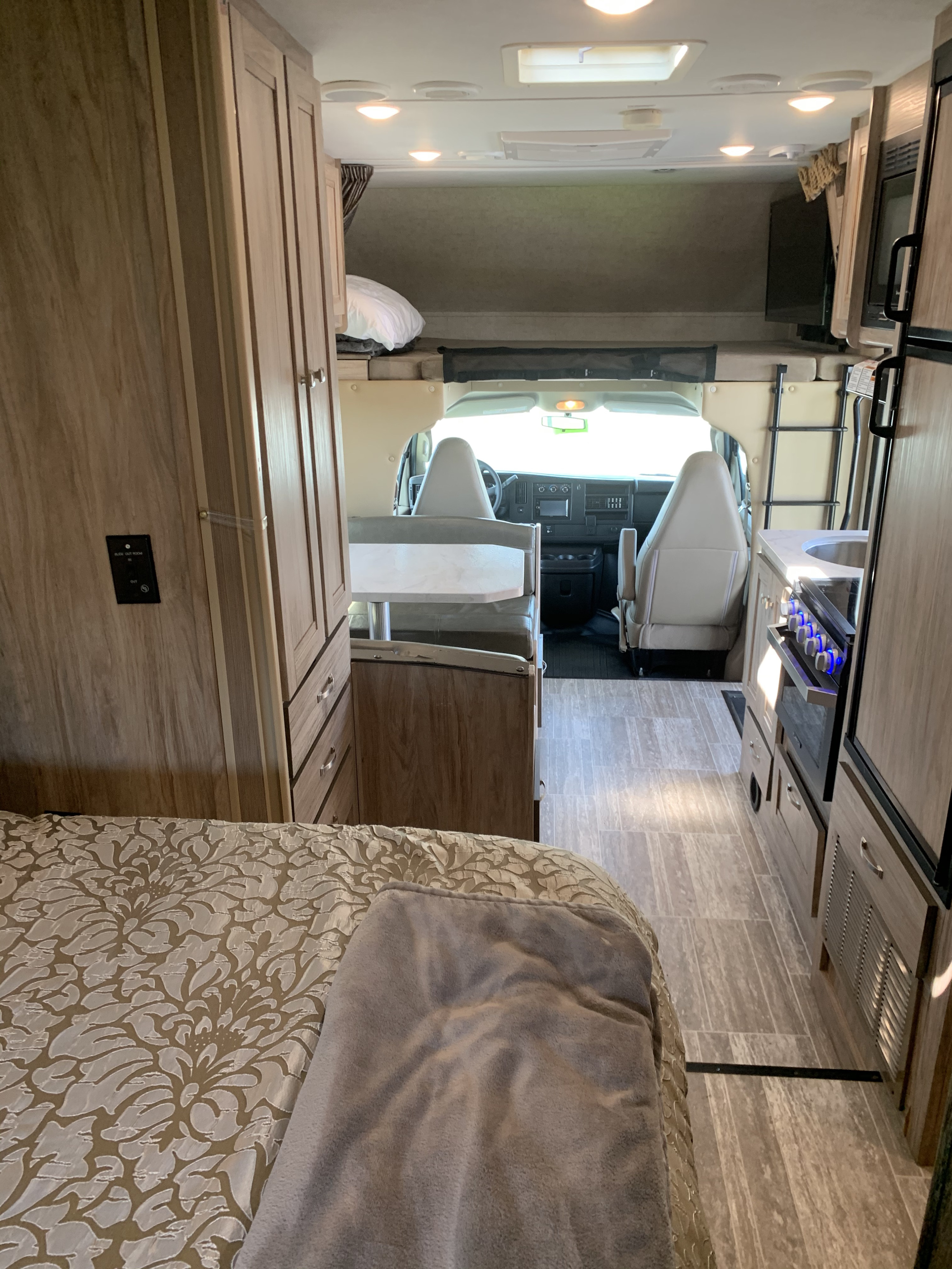 View of a well-equipped RV rental interior, showing the bed, kitchen, dinette, and front cockpit. Perfect for road trips.. Forest River Forester 2018