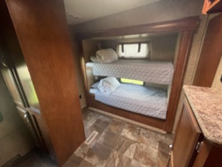 RV rental interior shows comfortable stacked bunk beds. Ideal for family camping and travel.. K-Z Manufacturing Durango 2014
