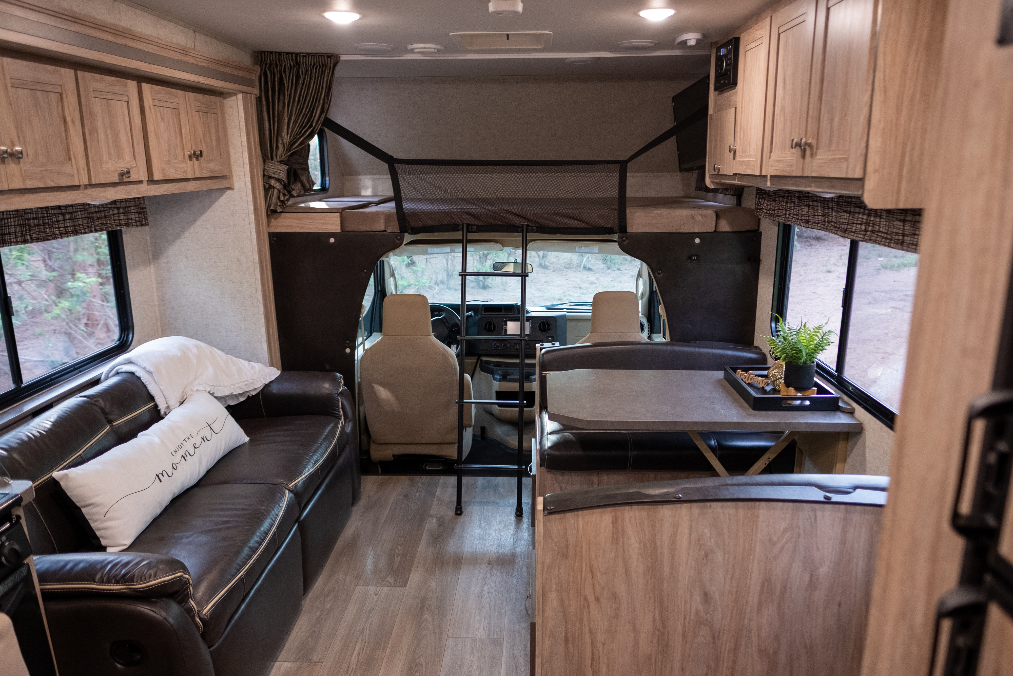 This spacious RV rental features a cozy living area, dining booth, and cab-over bunk, perfect for family adventures.. Forest River Sunseeker LE 2017