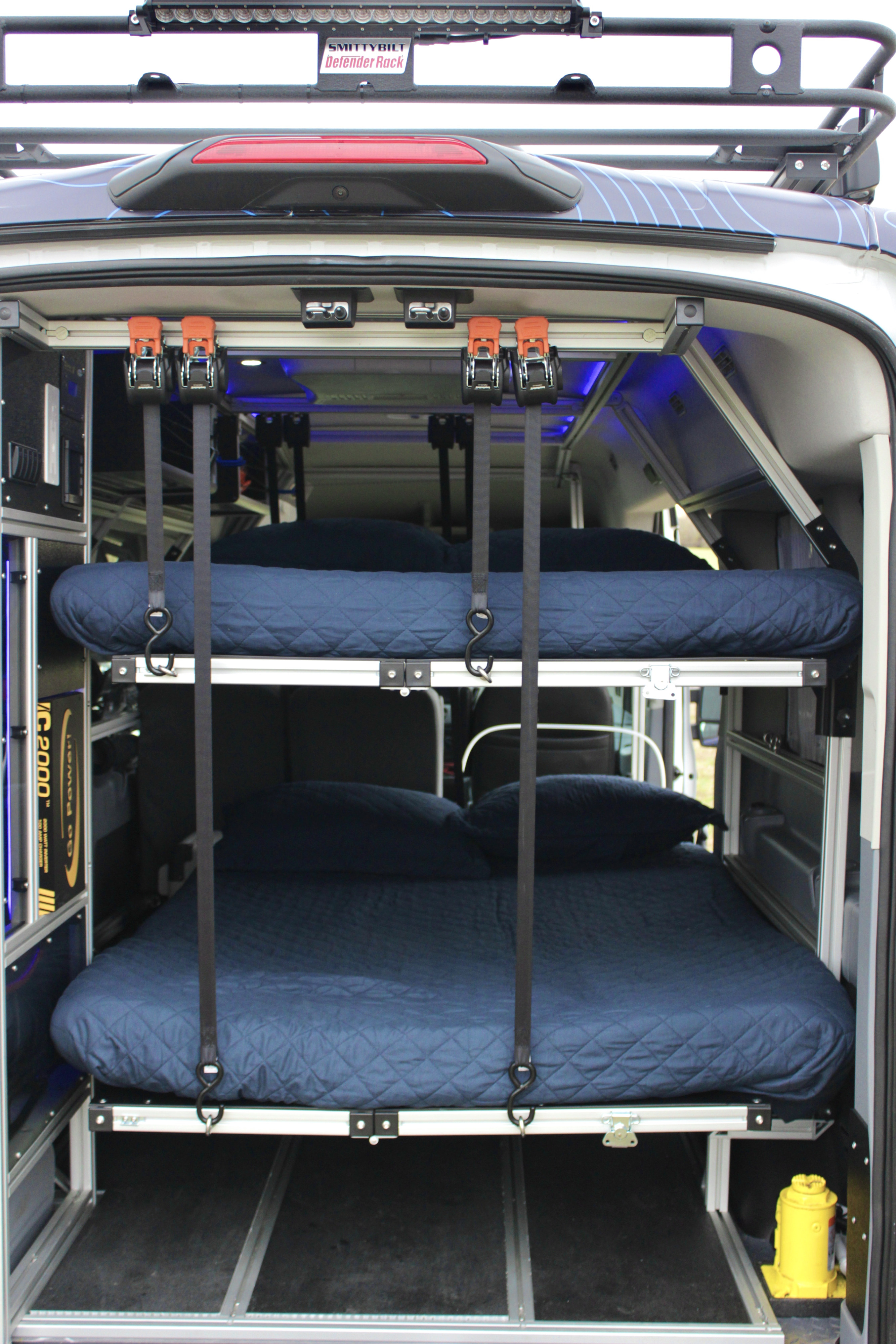 Modular bunk beds inside a custom RV rental, complete with power system & roof rack. Ideal for mobile adventures.. vandoit DO 2018
