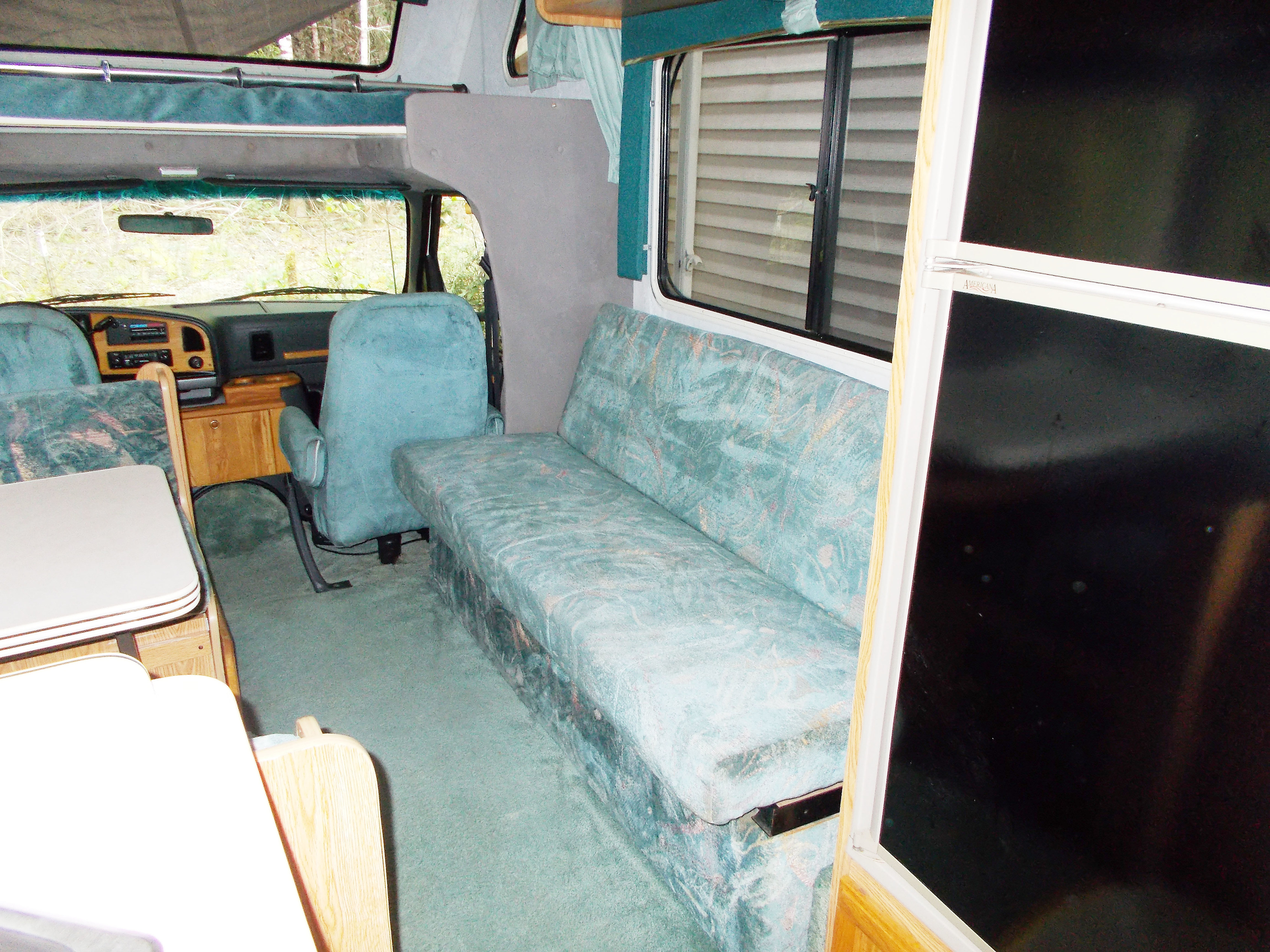 Shows fold out couch. Seat belts for two are not visible when bed is in this couch position.. Gulf Stream Conquest Lite 1996