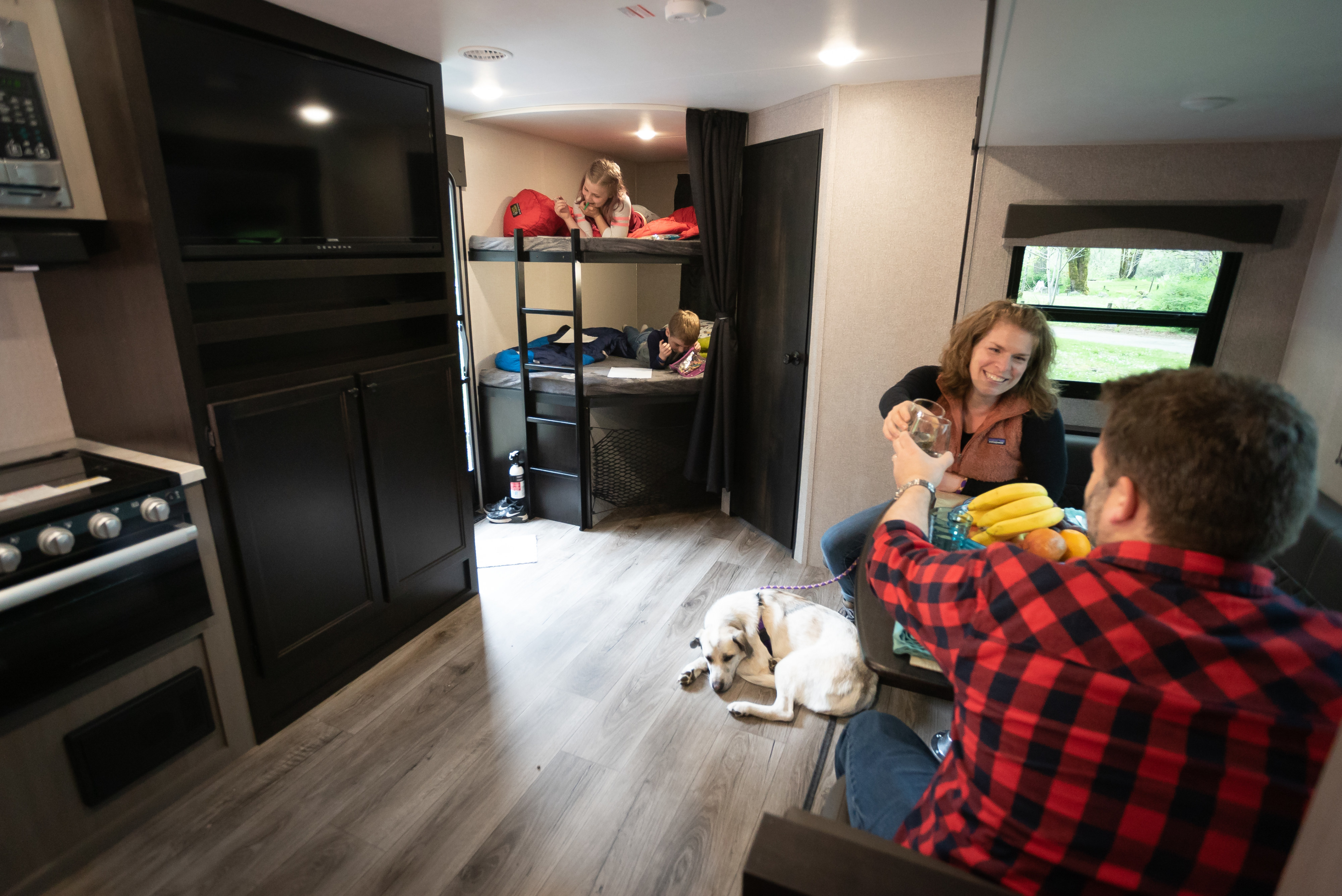 Family fun in an RV rental! Adults clink glasses, kids read in bunk beds, and their dog naps inside this cozy home on wheels.. Starcraft Super Lite 2021