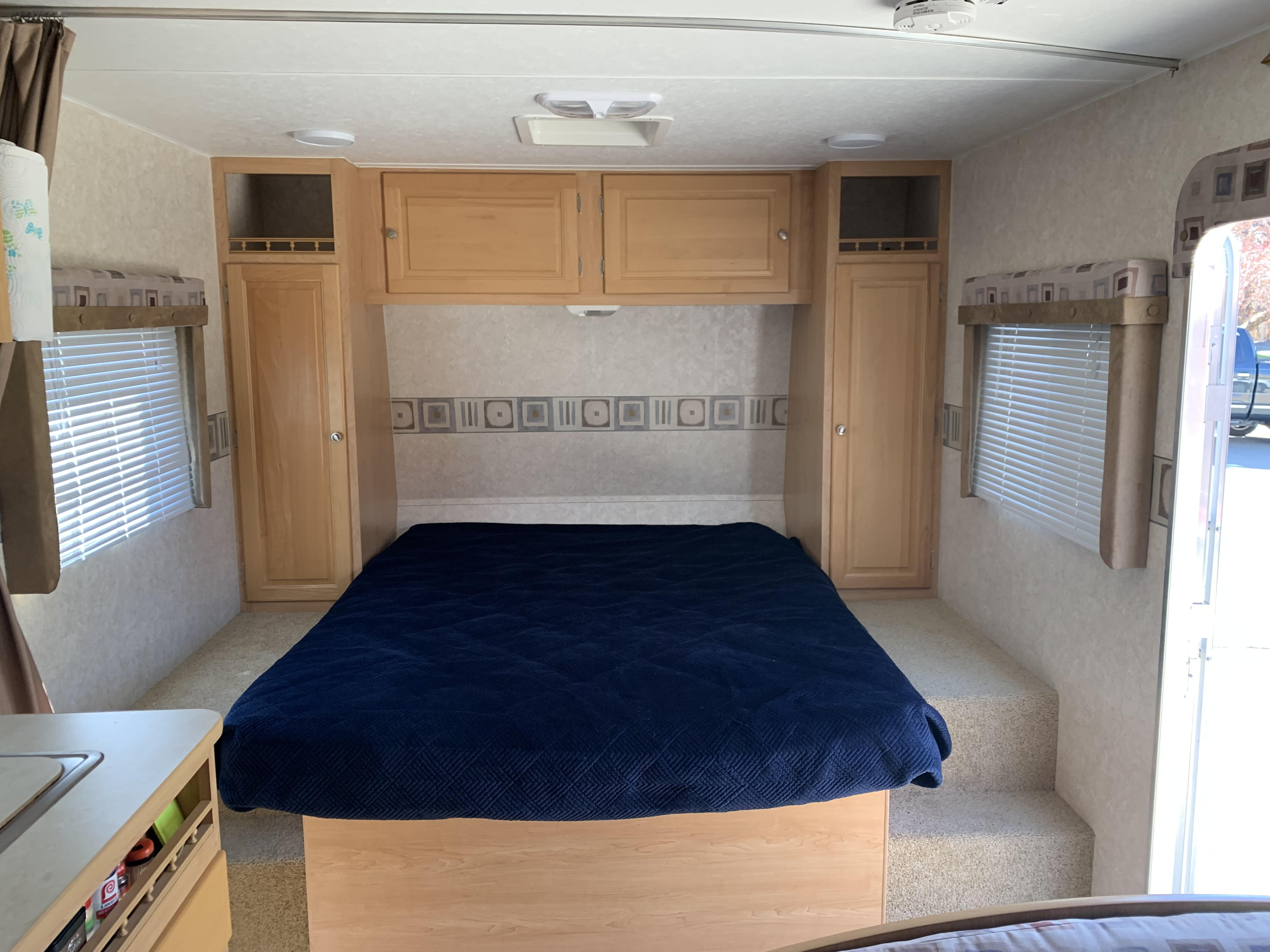 Queen bed located conveniently in front of camper by front door.  . Thor Wave 2006