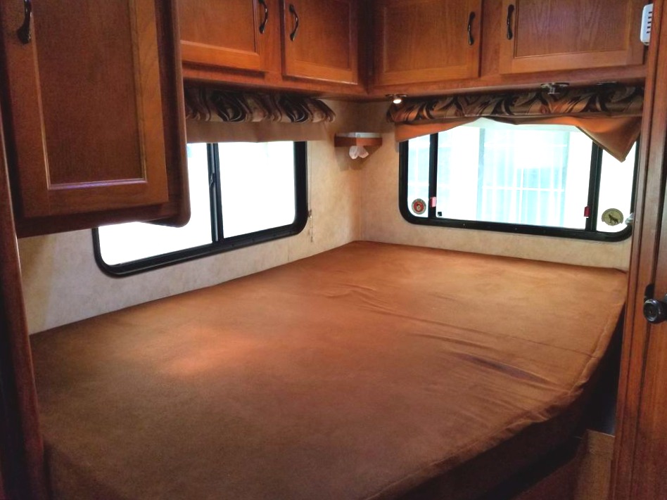 This bed is a "XL Full" 54x80  - the length of a queen and width of a full. Sleeps 2 comfortably.  This area has a small TV and a privacy curtain.. Forest River Coachmen Freelander 2012