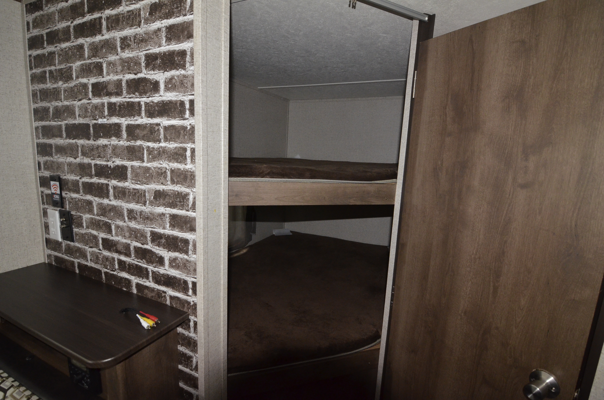 Inside this RV rental: comfortable bunk beds and a functional desk with media hookups. Perfect for family adventures.. Shasta 26BH 2019