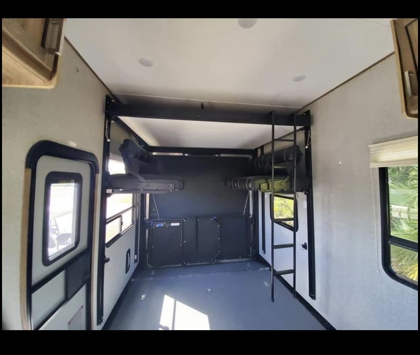 Spacious RV rental interior with convertible bunk beds and a large cargo/garage area. Ideal for toy hauler adventures.. Dutchmen Endurance 2019