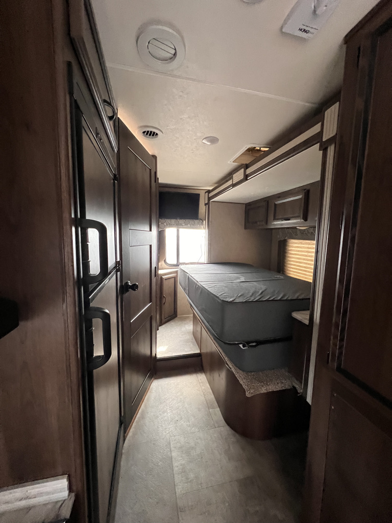 Cozy RV rental interior with bunk beds, fridge, and entertainment. Ideal for family travel adventures.. Coachmen Freelander 2019