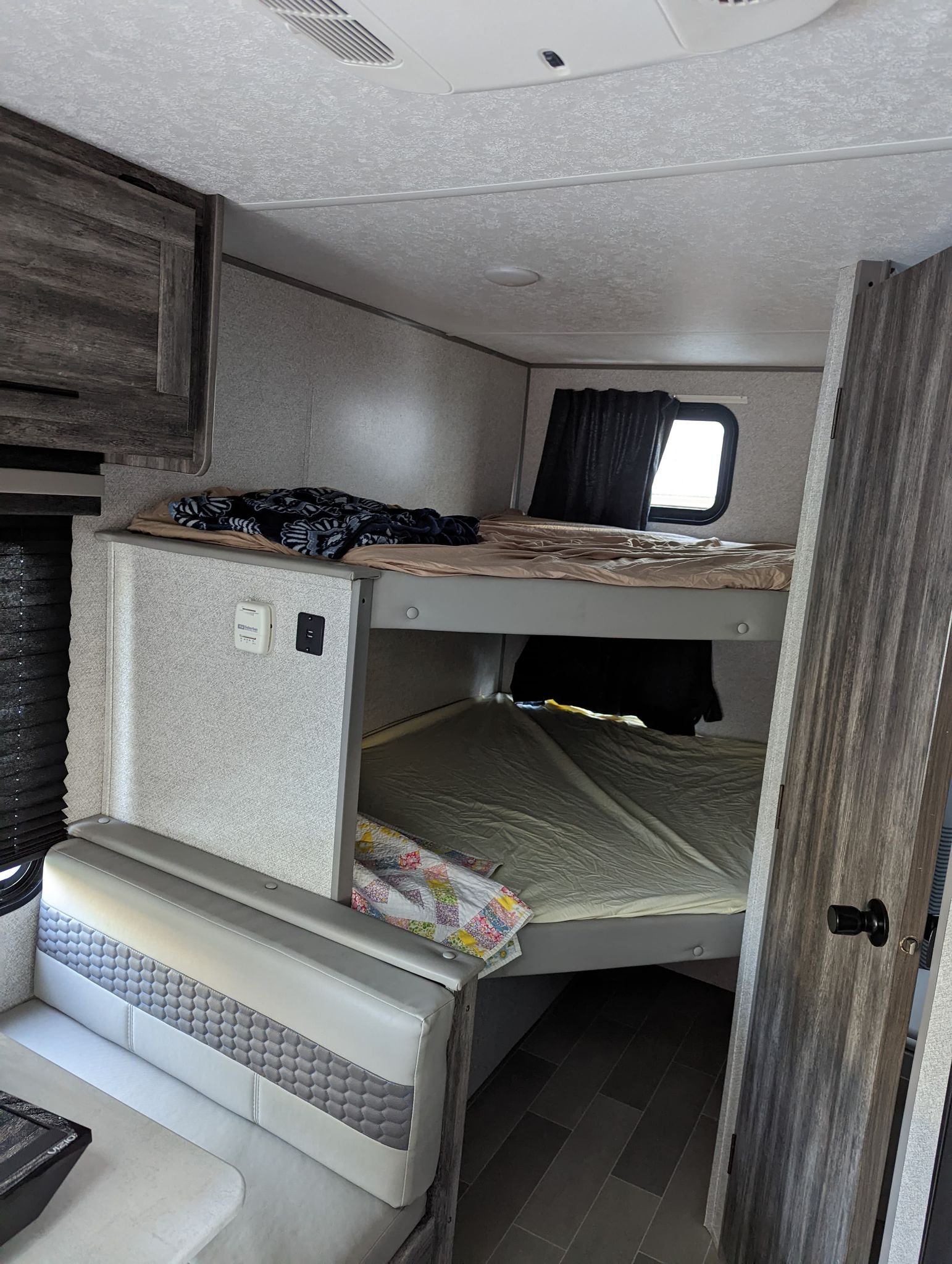 Spacious RV rental interior featuring comfortable bunk beds and a cozy dinette, perfect for family adventures.. Forest River Salem FSX 2021
