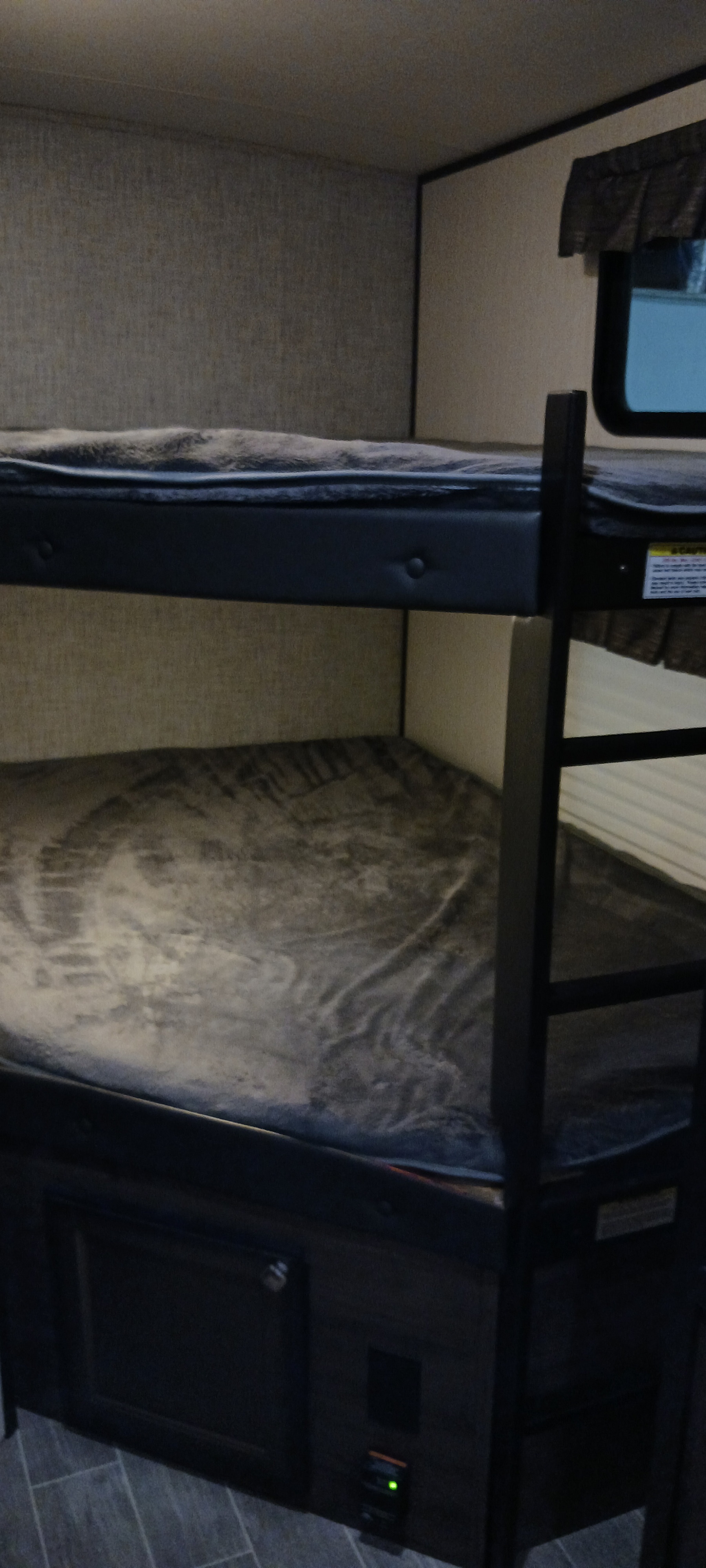 Inside an rv rental: cozy bunk beds with a ladder, offering a comfortable sleeping area.. Heartland Mallard 2020
