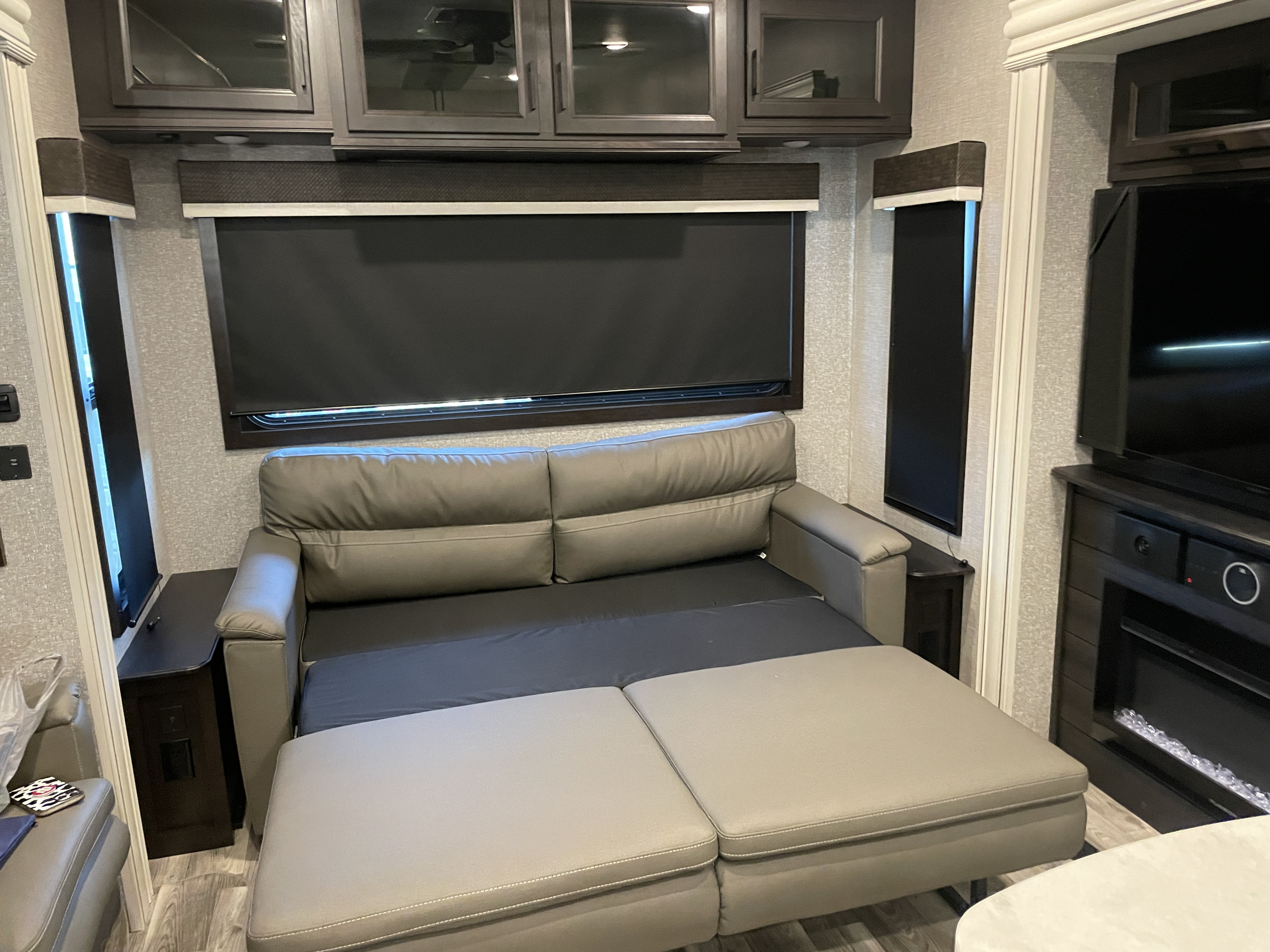 This RV rental features a cozy pull-out sofa bed in the living area, complete with overhead cabinets, windows, and a fireplace.. Jayco Eagle 2022
