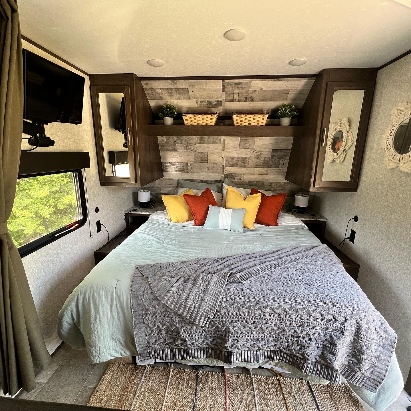 Cozy RV rental bedroom with a comfy bed, modern decor, and a window view. Ideal for travel.. Dutchmen Coleman Lantern LT 2020