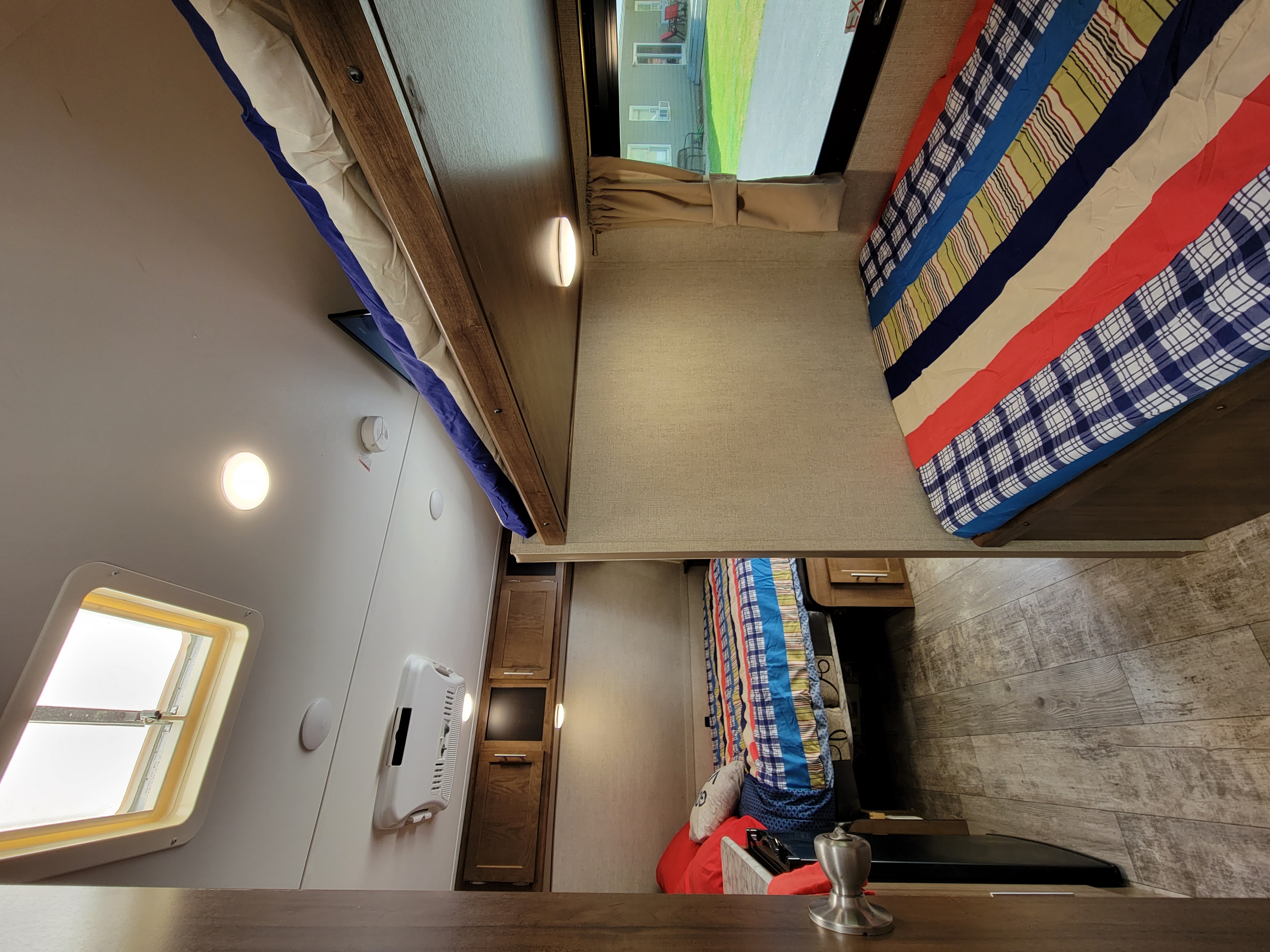 Cozy RV rental interior with bright bunk beds, a clear window view, and ample lighting for travel comfort.. Gulf Stream Ameri-Lite Super Lite 2019