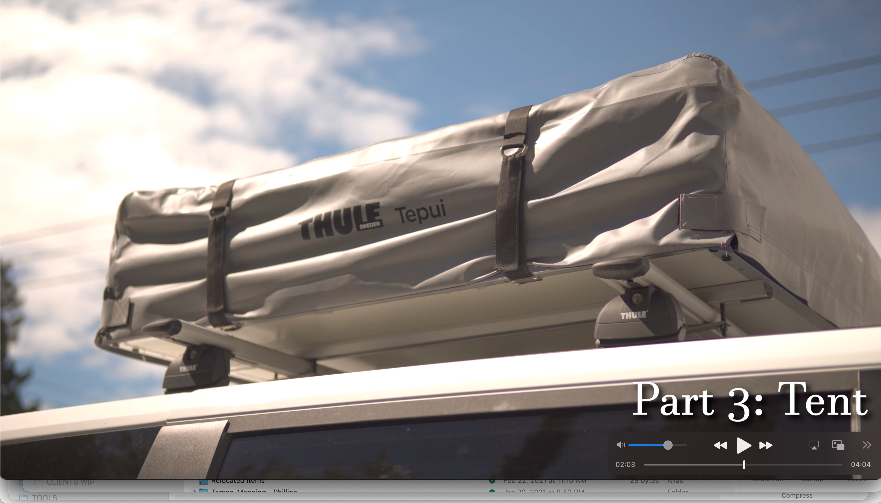 A gray Thule Tepui rooftop tent is securely mounted on a vehicle, ready for your next RV rental adventure or camping trip.. Dodge Grand Caravan 2019