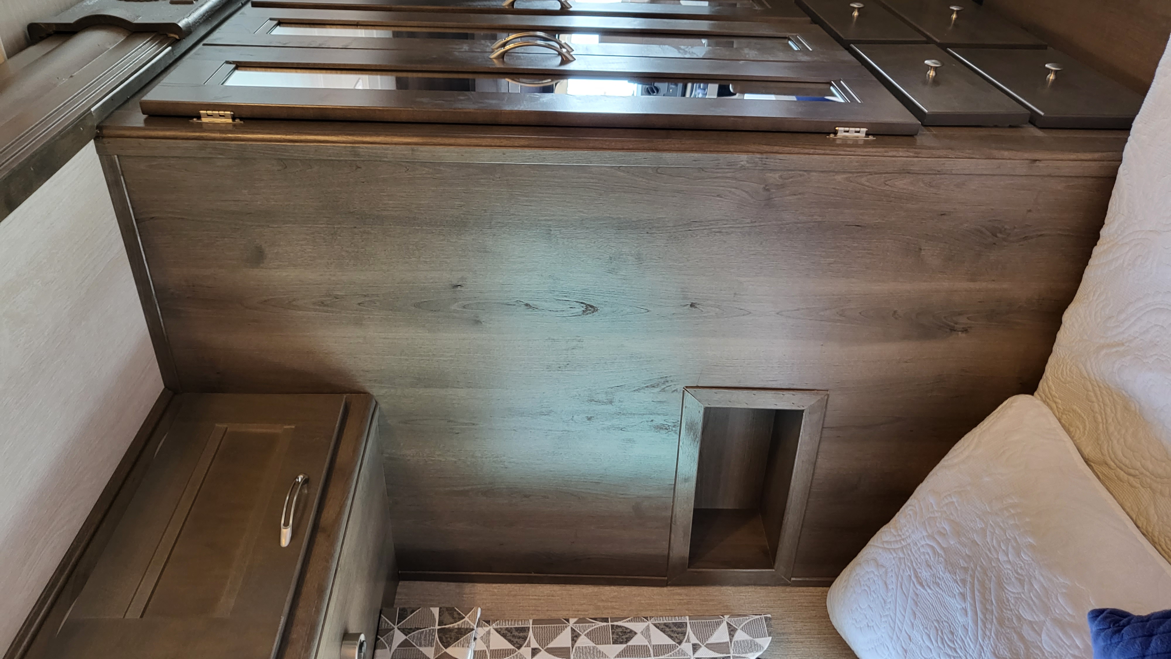 Convenient cell phone storage for the queen bed. Nexus RV Triumph 2022