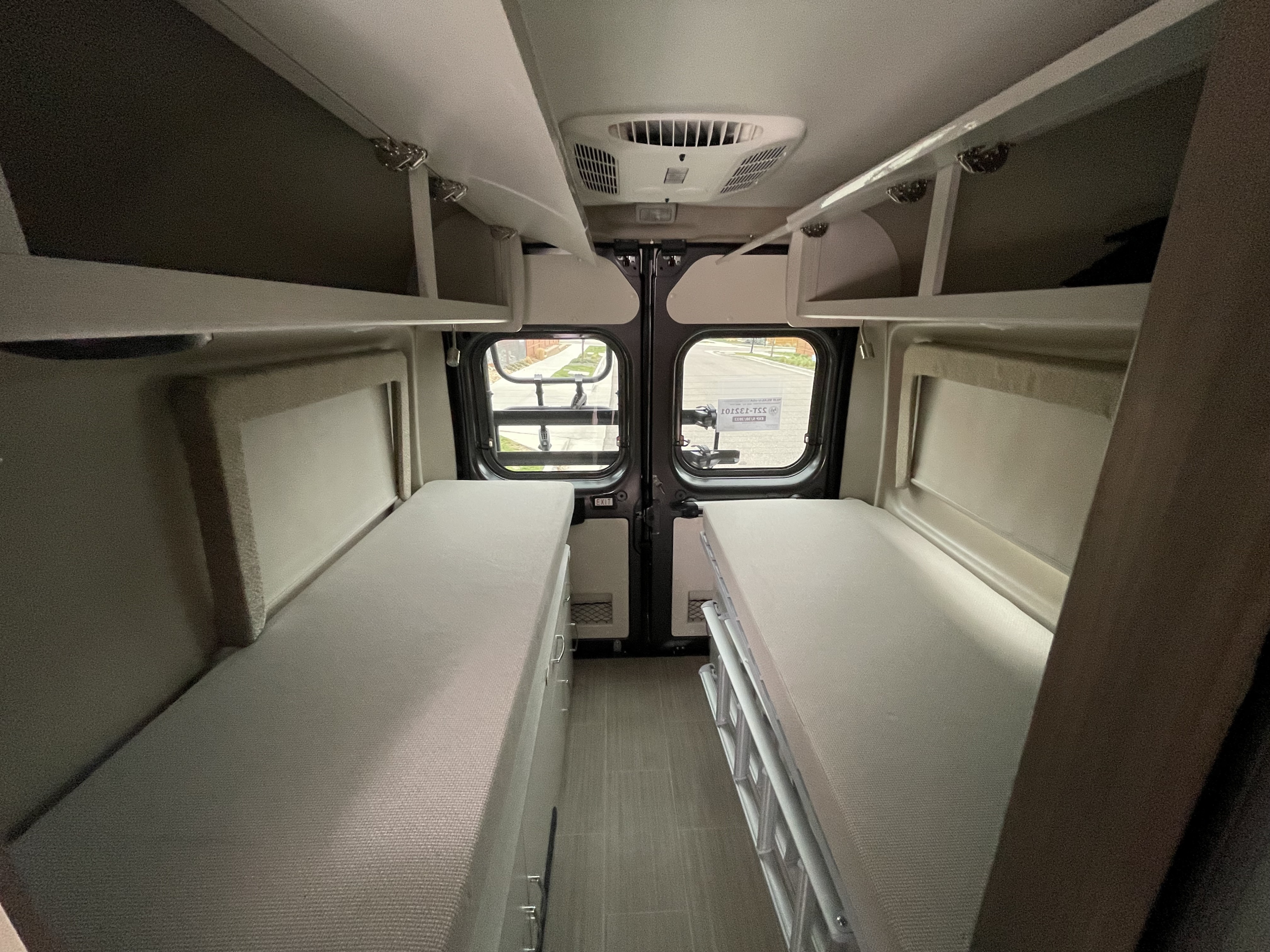 Spacious RV rental interior with dual beds, overhead storage, and AC for comfortable travel.. Thor Tellaro 2022