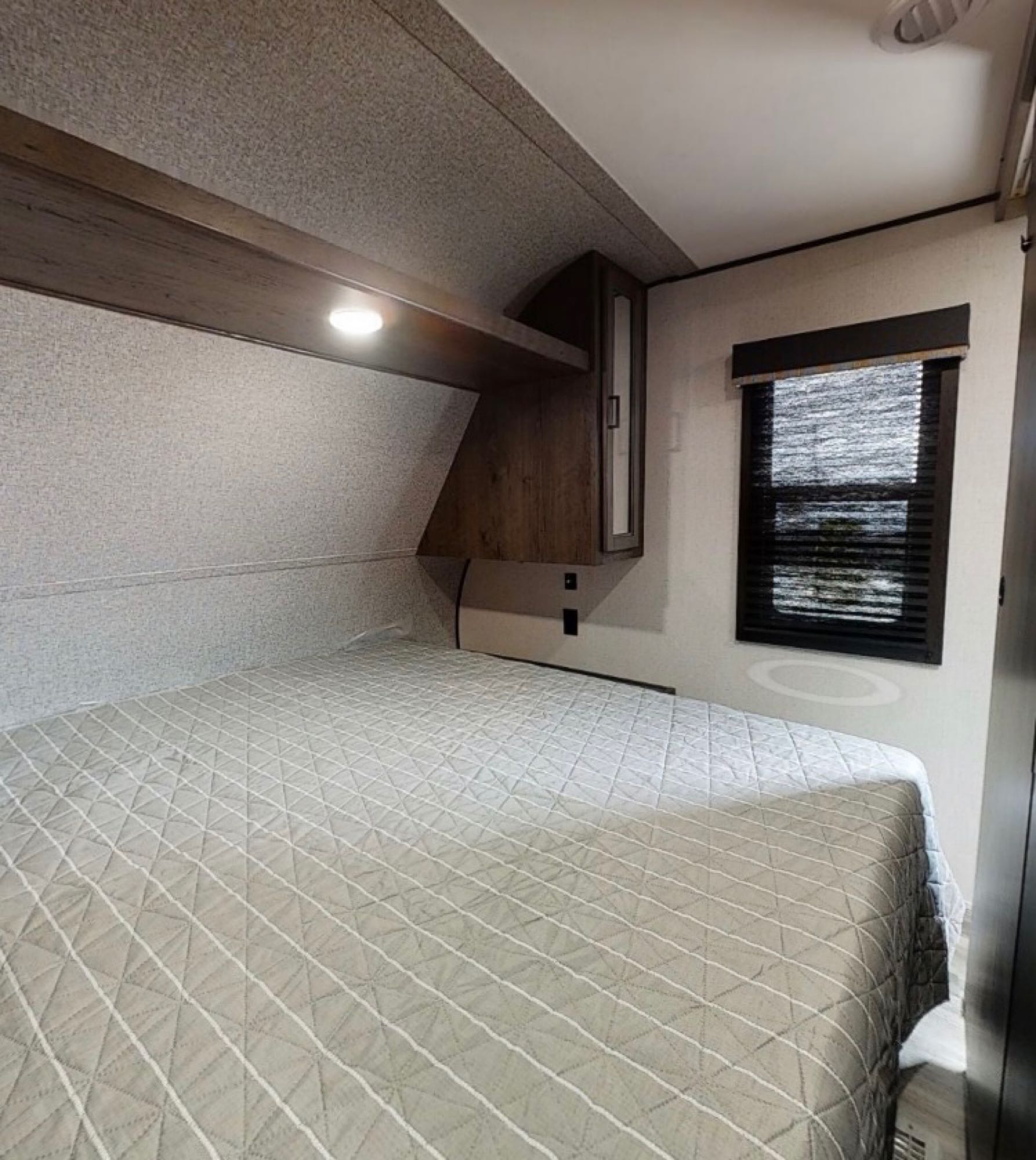 Wardrobe storage above bed and hanging storage on both sides of bed. Large storage space underneath bed.. Starcraft Autumn Ridge 2022