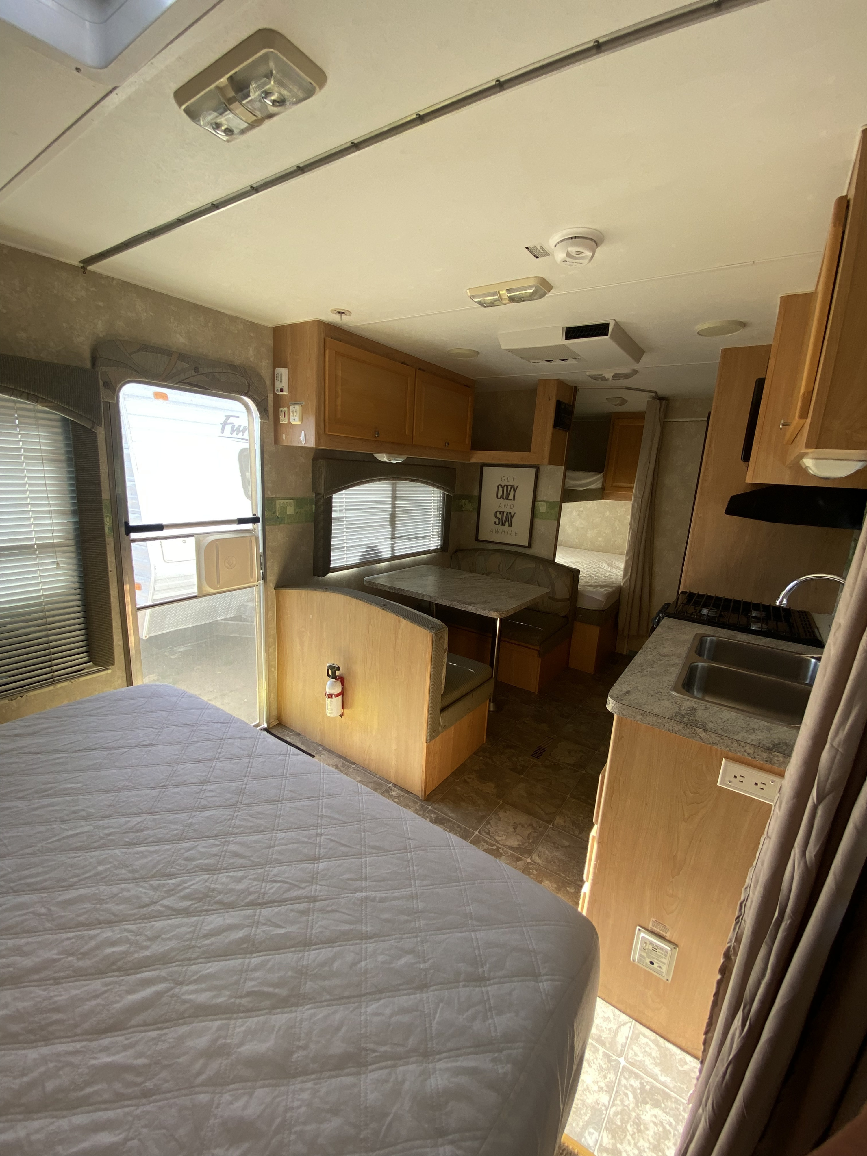 Your next rv rental is ready! This travel trailer interior has a comfy bed, dinette, and compact kitchen amenities.. Thor Summit 2008