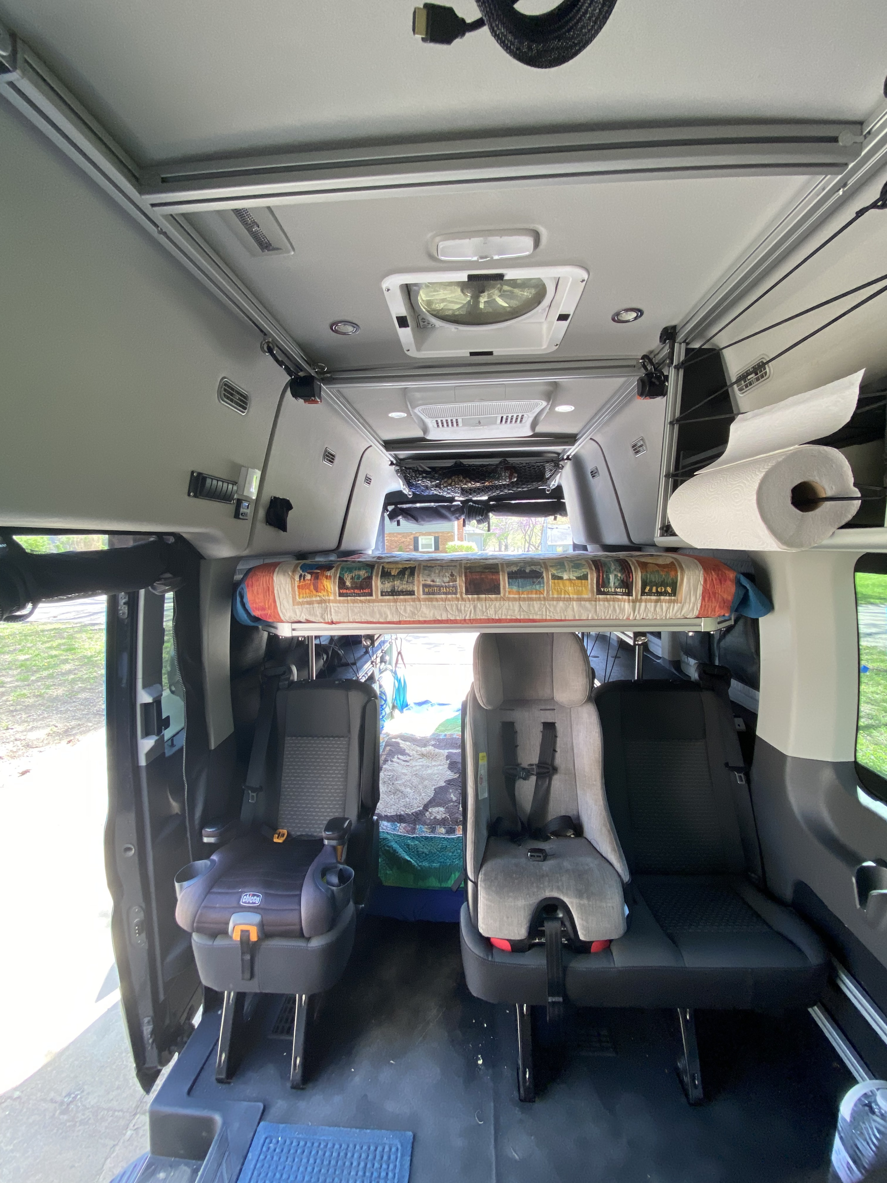 RV rental interior features overhead bunk, child seats, ceiling fan, and storage for family trips.. vandoit LIV 2020