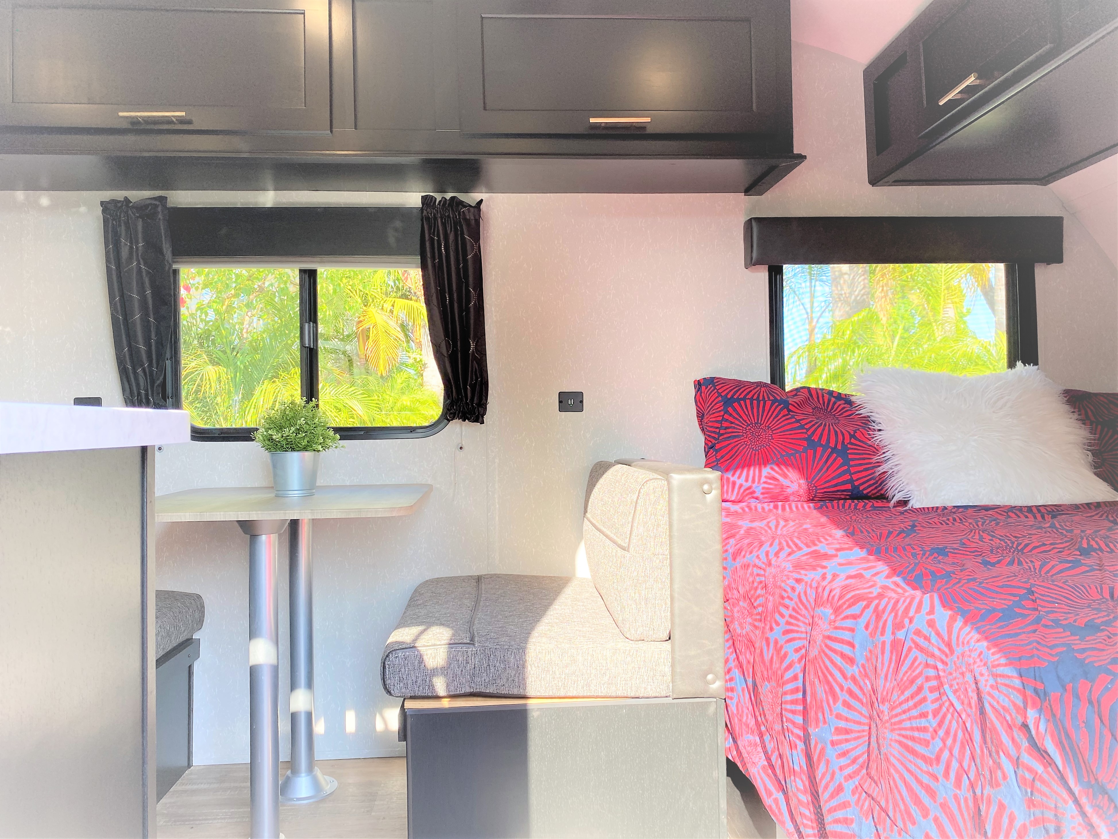 Experience comfort in this RV rental's bright interior. Features dining, cozy bedding, and cabinets in a compact space.. Forest River Cherokee Wolf Pup 2022
