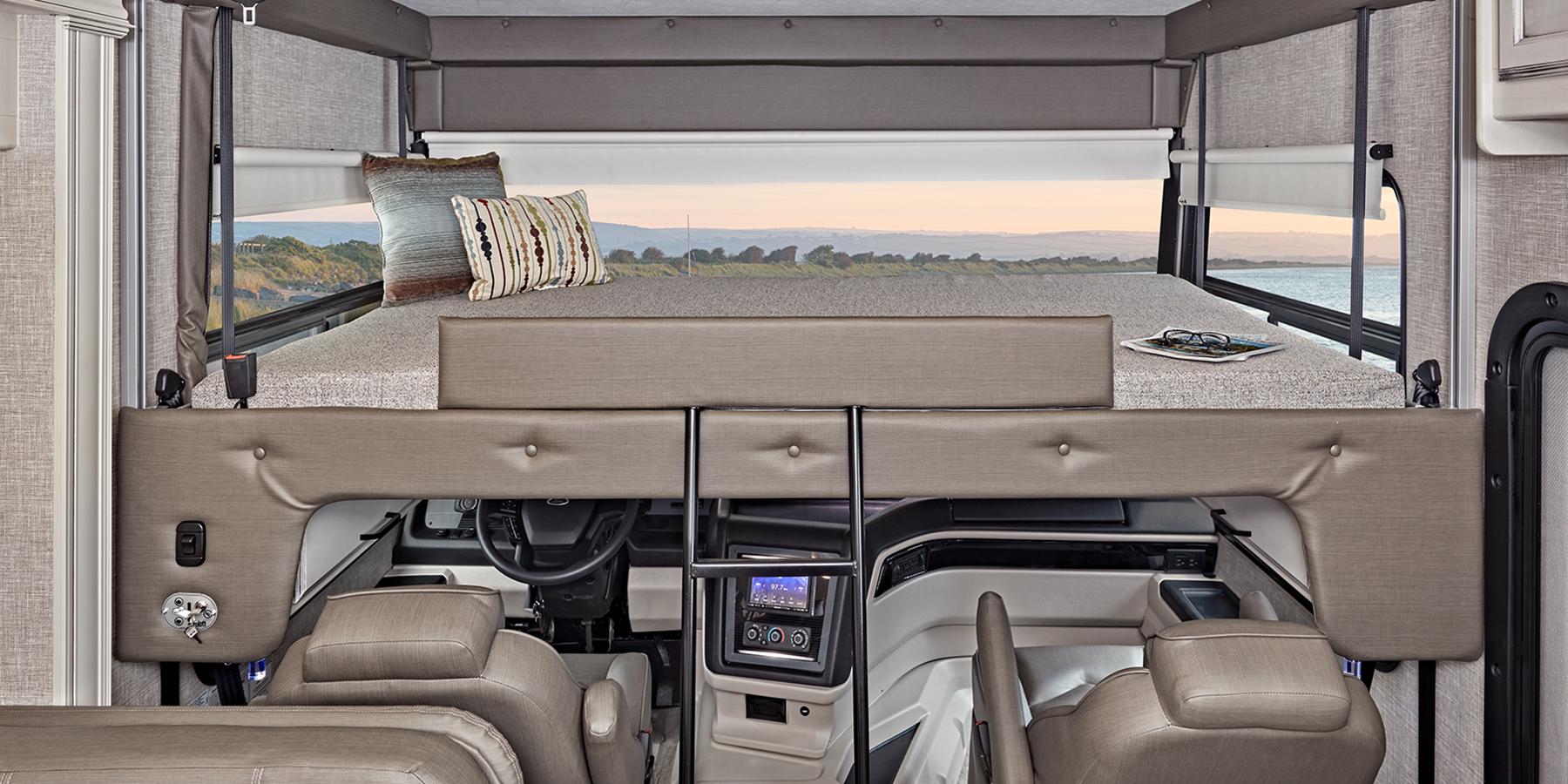 Spacious RV rental interior featuring an overhead bed above the cockpit, offering comfortable travel.. Jayco ALANTE 27a 2022