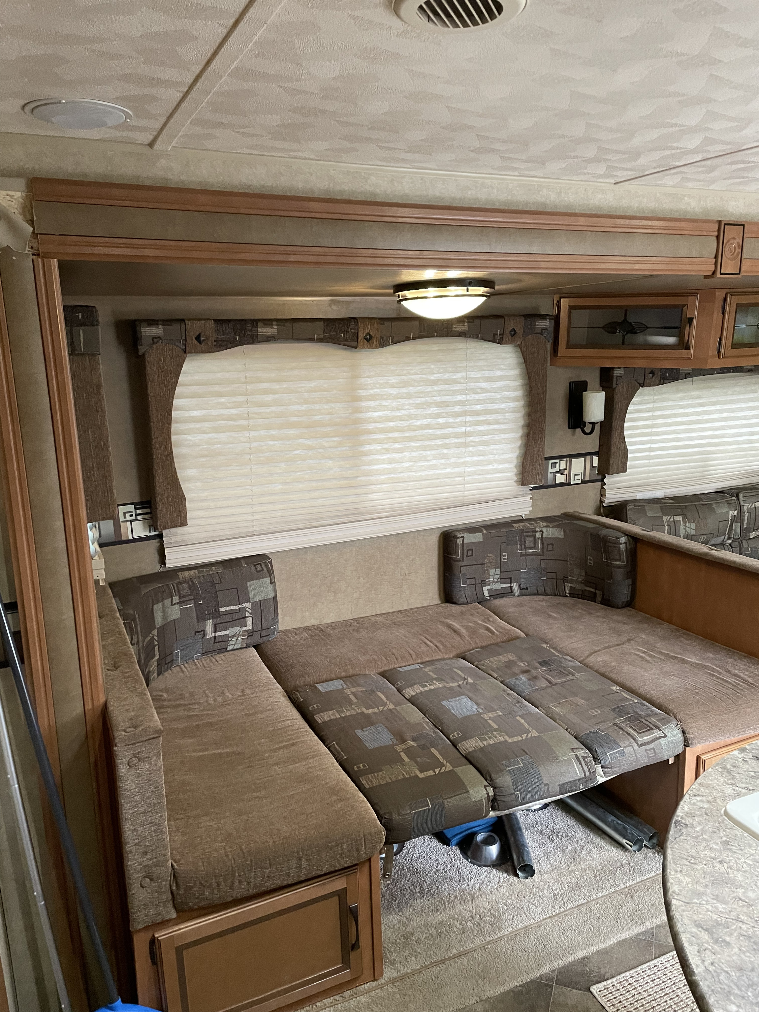 View of an RV rental's dinette area, featuring modular patterned cushions set up as a lounge or convertible bed.. Other Other 2014