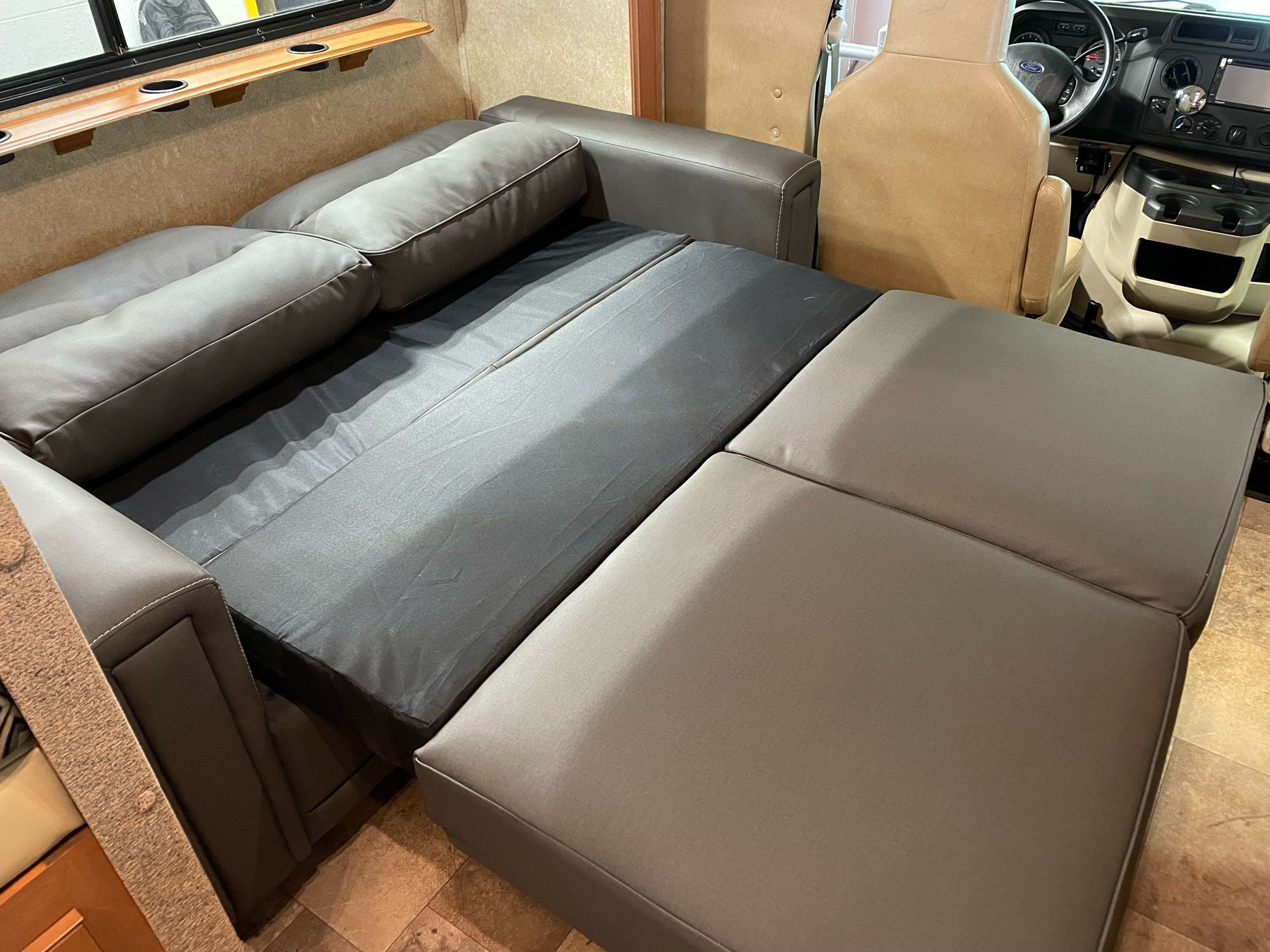 Spacious RV rental interior featuring a versatile pull-out sofa bed for comfortable living.. Forest River Sunseeker 2013