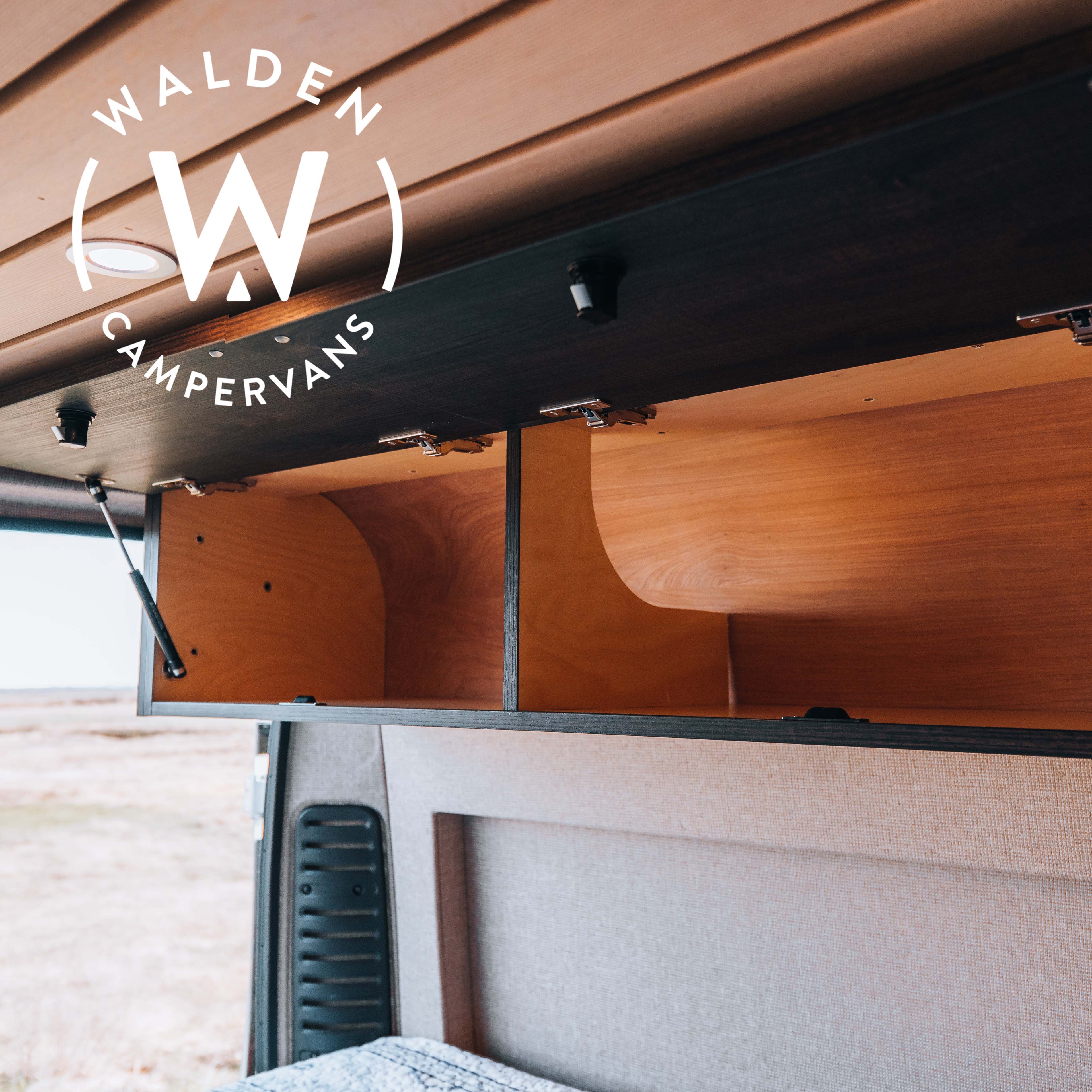 Walden Campervans RV rental interior: open wooden overhead cabinet, slatted ceiling, and cozy upholstered bed area.. ram Promaster 2021