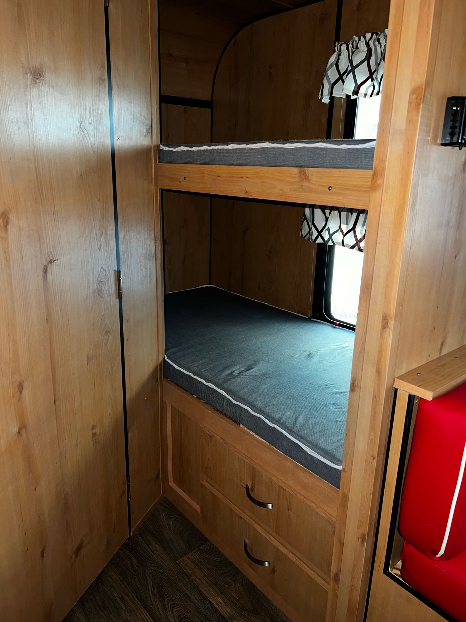 Inside an RV rental: cozy bunk beds with comfy mattresses and built-in storage. Ideal for road trip accommodations.. Old School Trailers 821 2022
