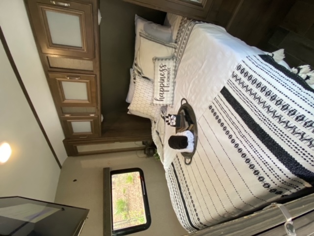 Queen bed with memory foam topper with pillows and linens.. Keystone RV Passport Grand Touring 2019