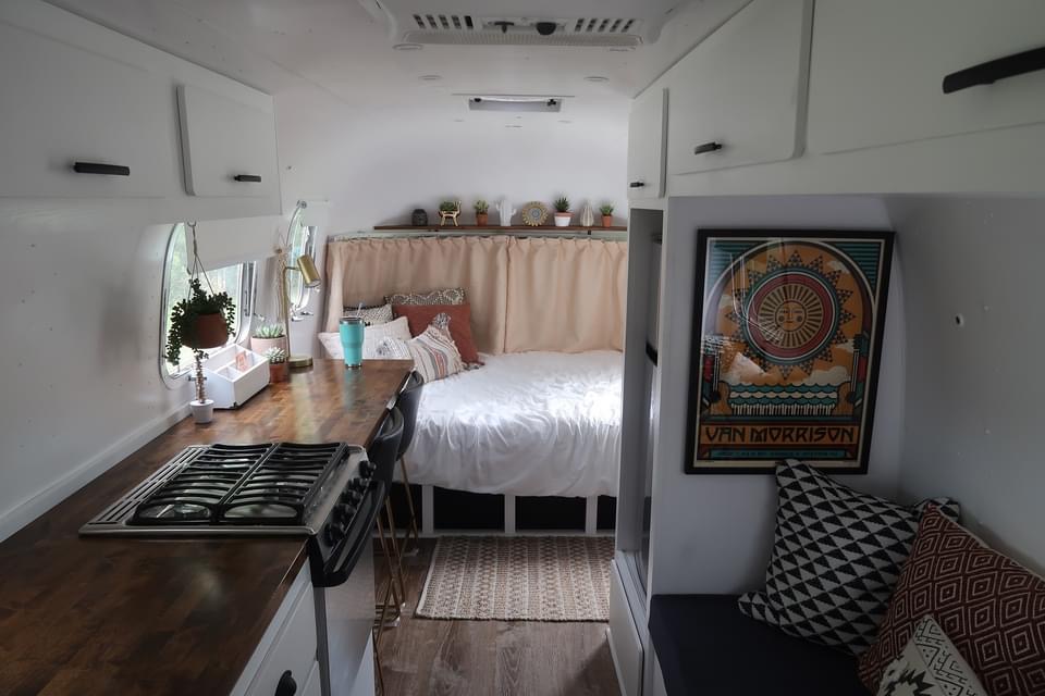 Cozy RV rental: full view of stylish interior with kitchen, bed, & lounge area, perfect for travel.. Airstream Argosy 1979