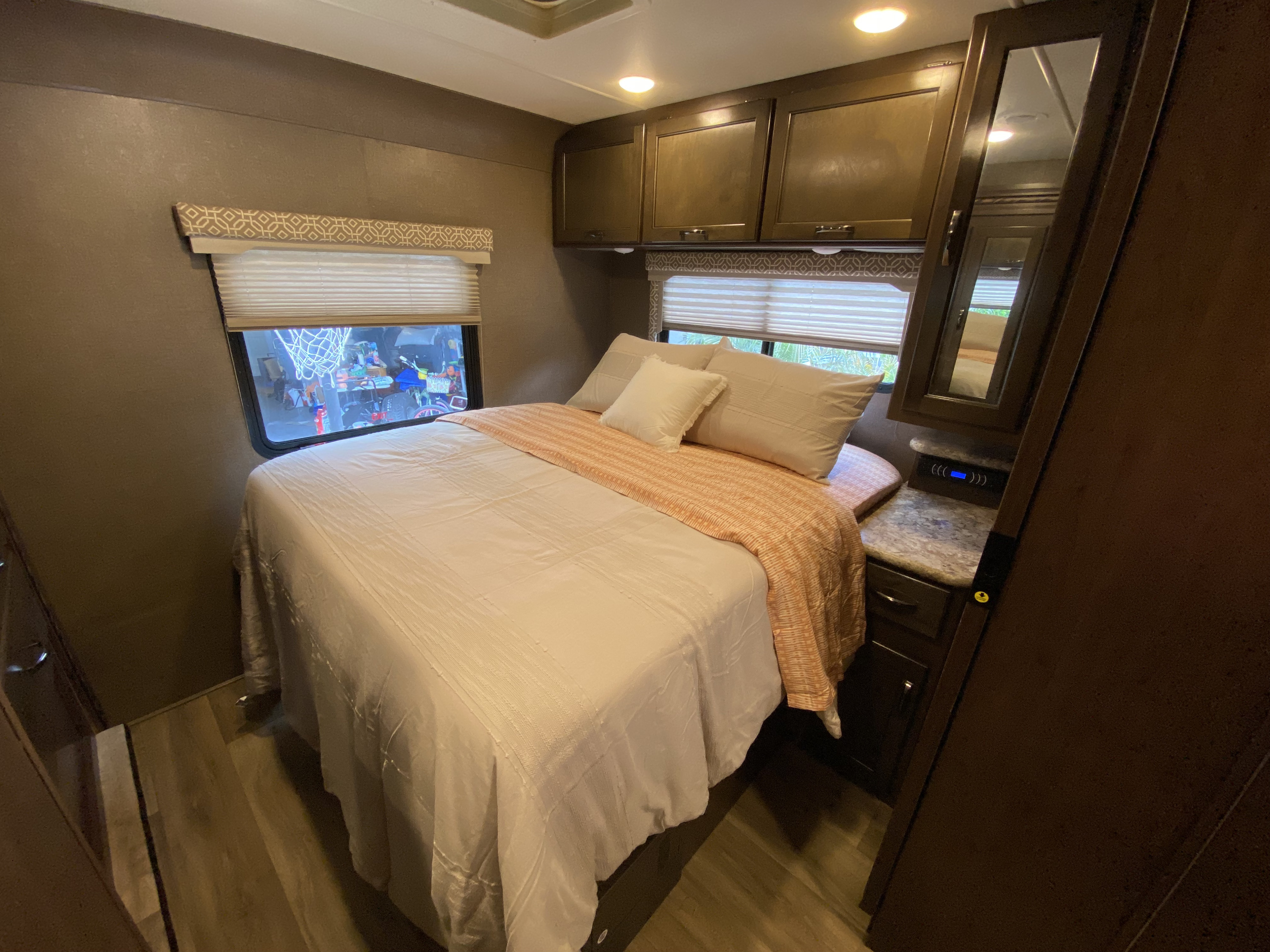 Comfortable RV rental bedroom interior with bed, overhead storage, and window blinds. Ideal for your next adventure.. Thor Freedom Elite 2018