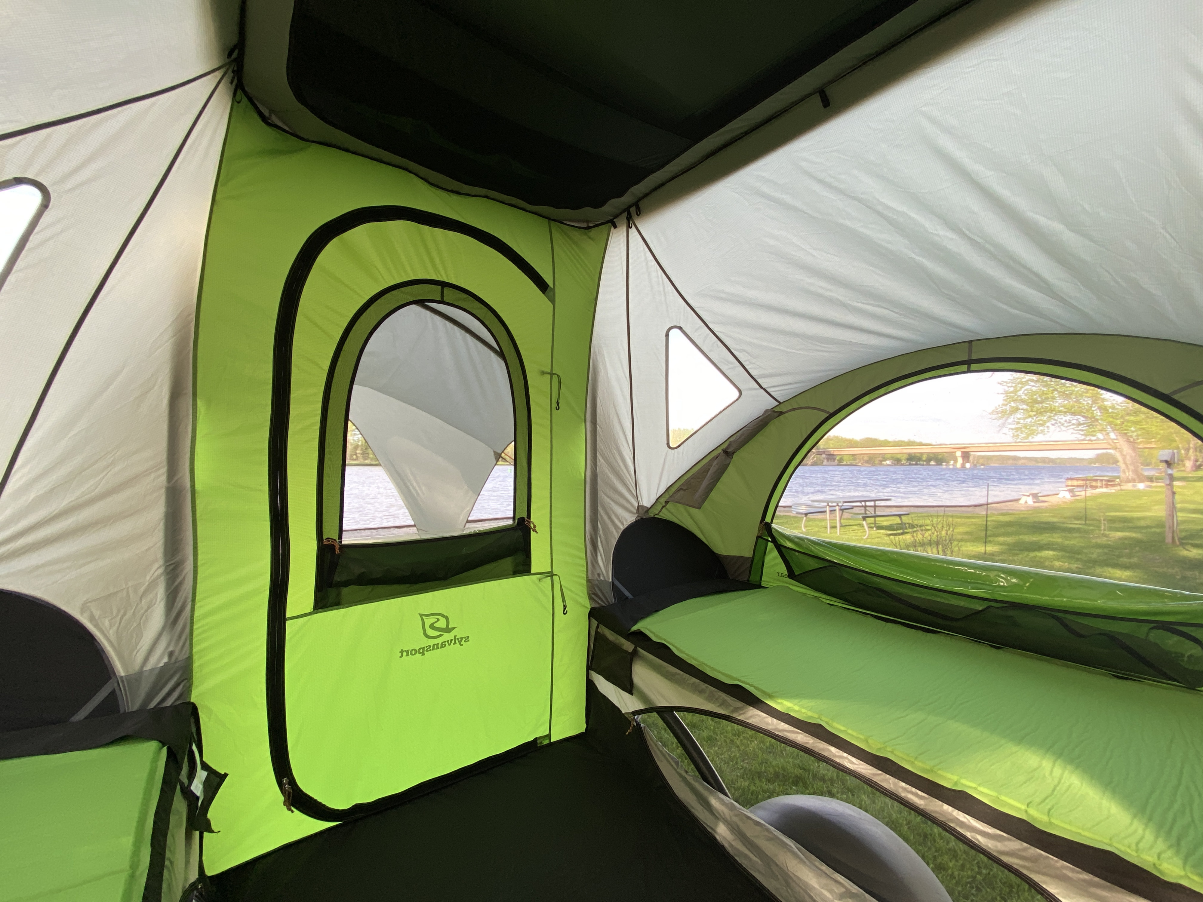 Bright SylvanSport tent interior with comfy pads and serene lake view. Ideal for your RV rental adventure.. SylvanSport GO 2022
