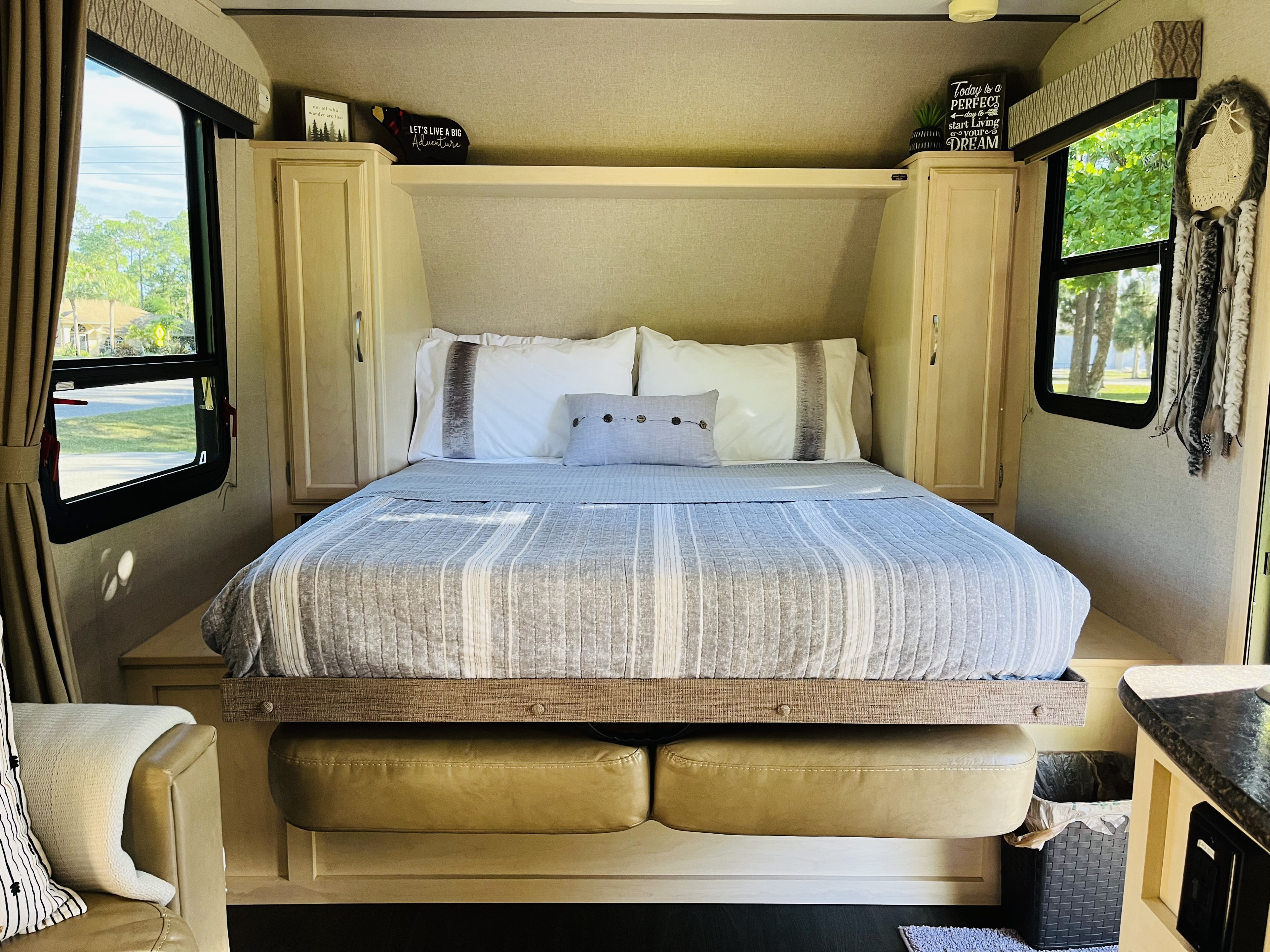 This RV rental bedroom offers a cozy, adventurous retreat with a comfortable bed and inspiring decor, ready for your next journey.. Winnebago Micro Minnie 2018