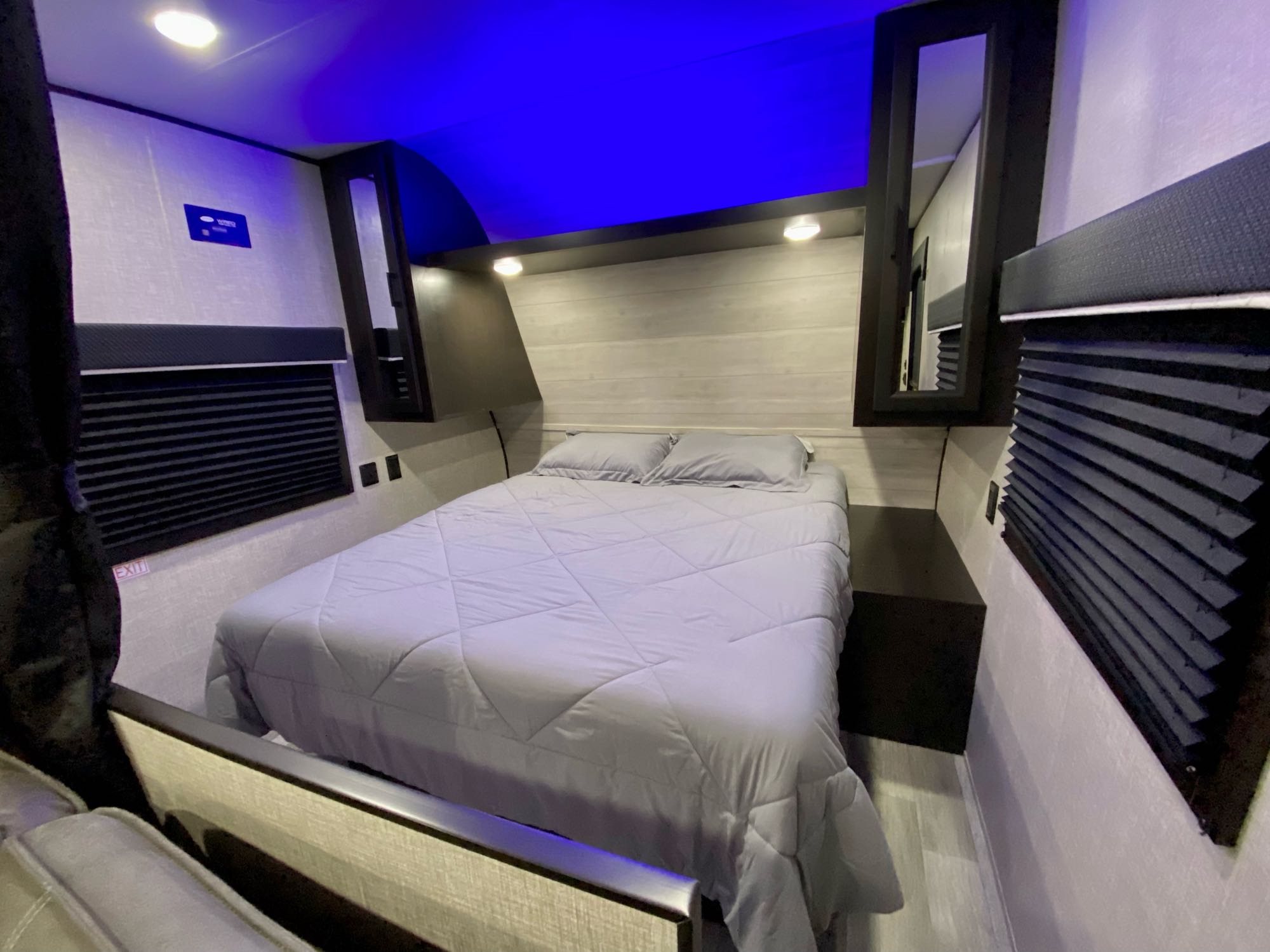 Comfortable RV rental bedroom with a cozy bed, built-in storage, and ambient blue lighting, ideal for trips.. Jayco 264BH 2022