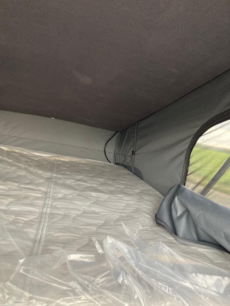 RV rental pop-top bed showing new, plastic-wrapped mattress. Perfect for comfortable camper travel.. RollerTeam Livingstone 5 Sport 2023