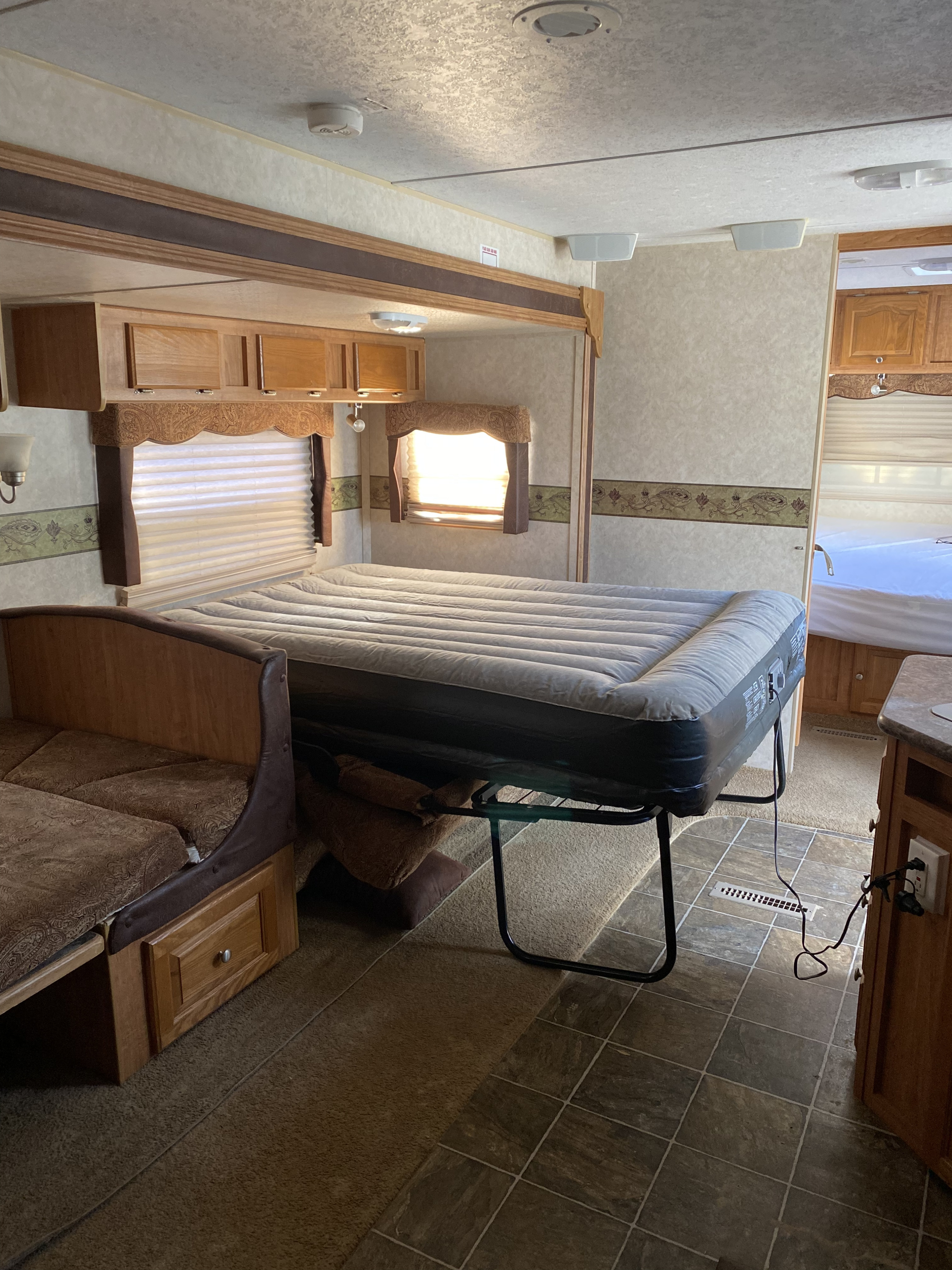 Experience comfort in this RV rental. Features include an inflatable air mattress on a frame, sofa seating, and storage.. Forest River Rockwood Signature Ultra 2010
