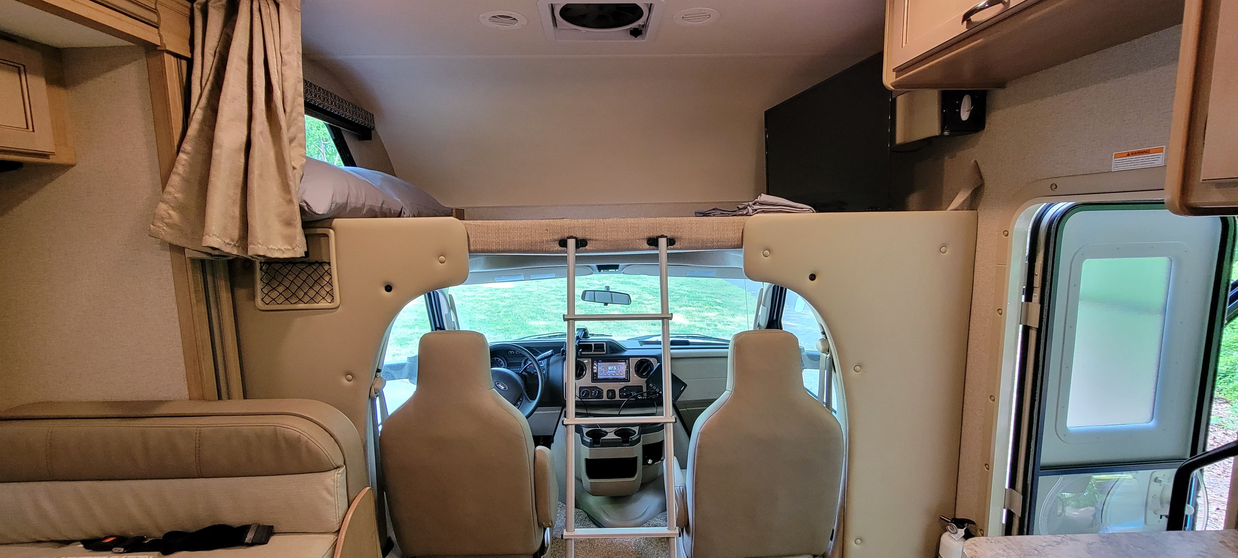 Interior of an RV rental: front cabin, overhead bunk, and main living area with dinette. Ready for travel!. Thor Four Winds 2020