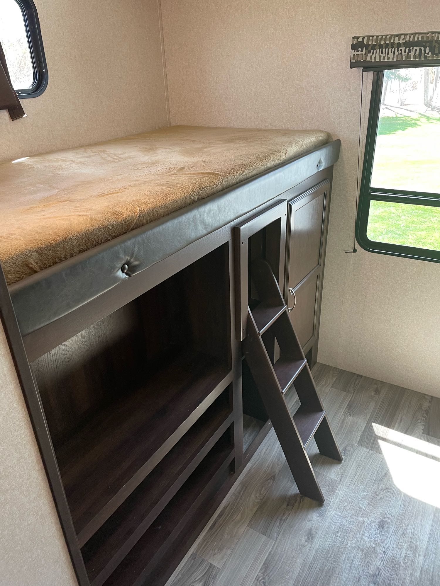 Inside this RV rental, find a comfortable bunk bed with a ladder, ample storage, and scenic window views. Perfect for travel adventures.. Jayco Jay Flight 2018