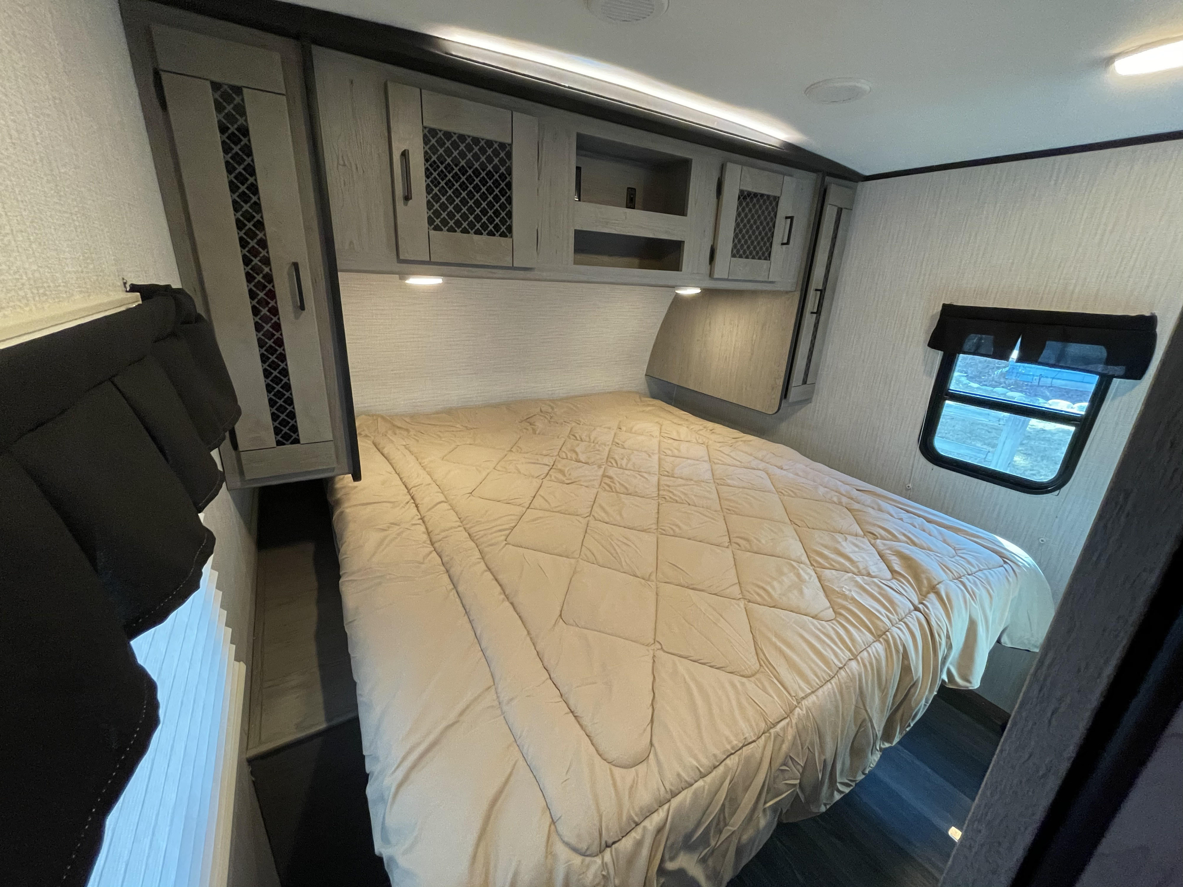 Cozy RV rental bedroom with a comfy bed and ample storage, perfect for your next adventure.. Heartland RVs Mallard 2021